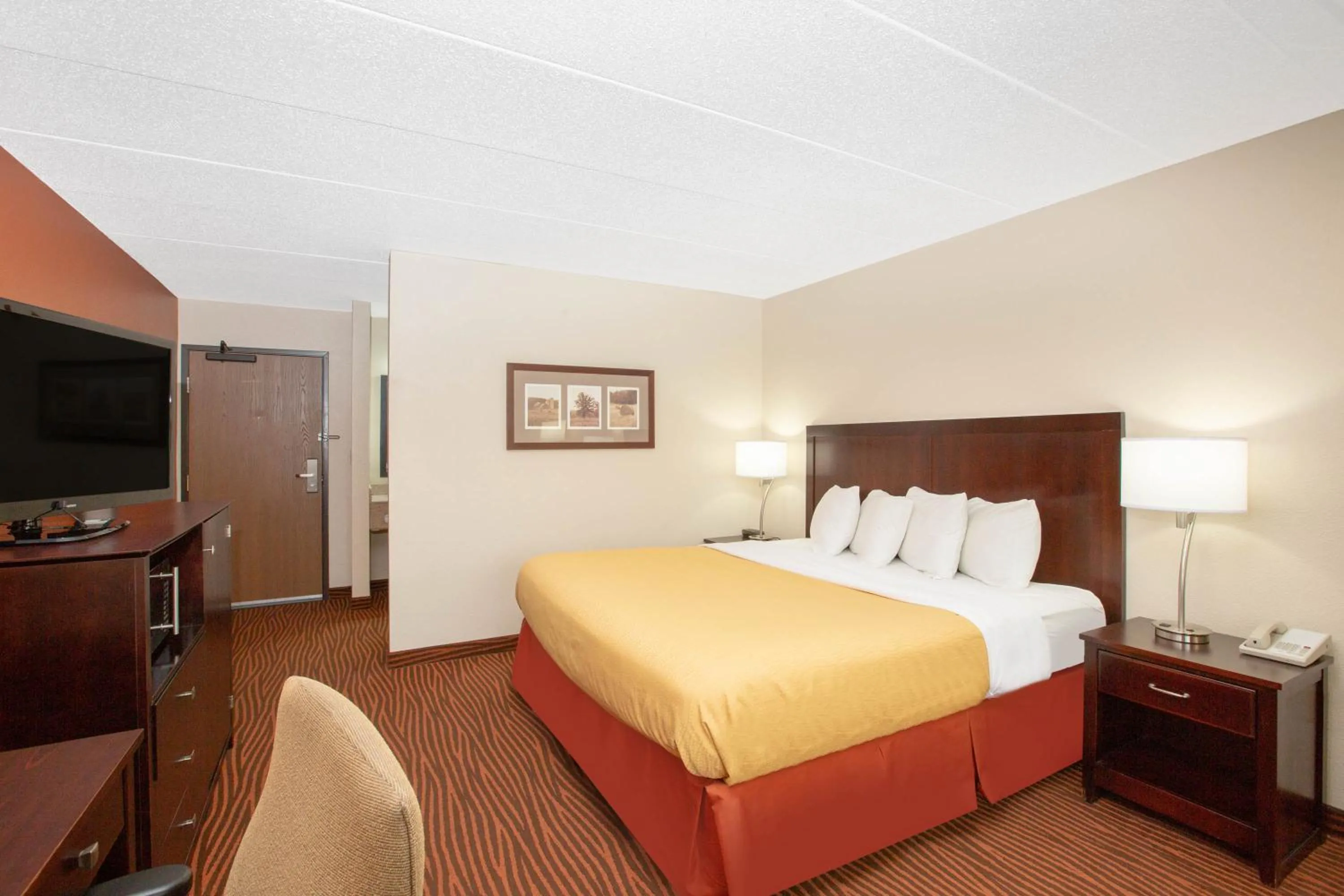 Bed in AmericInn by Wyndham Muscatine