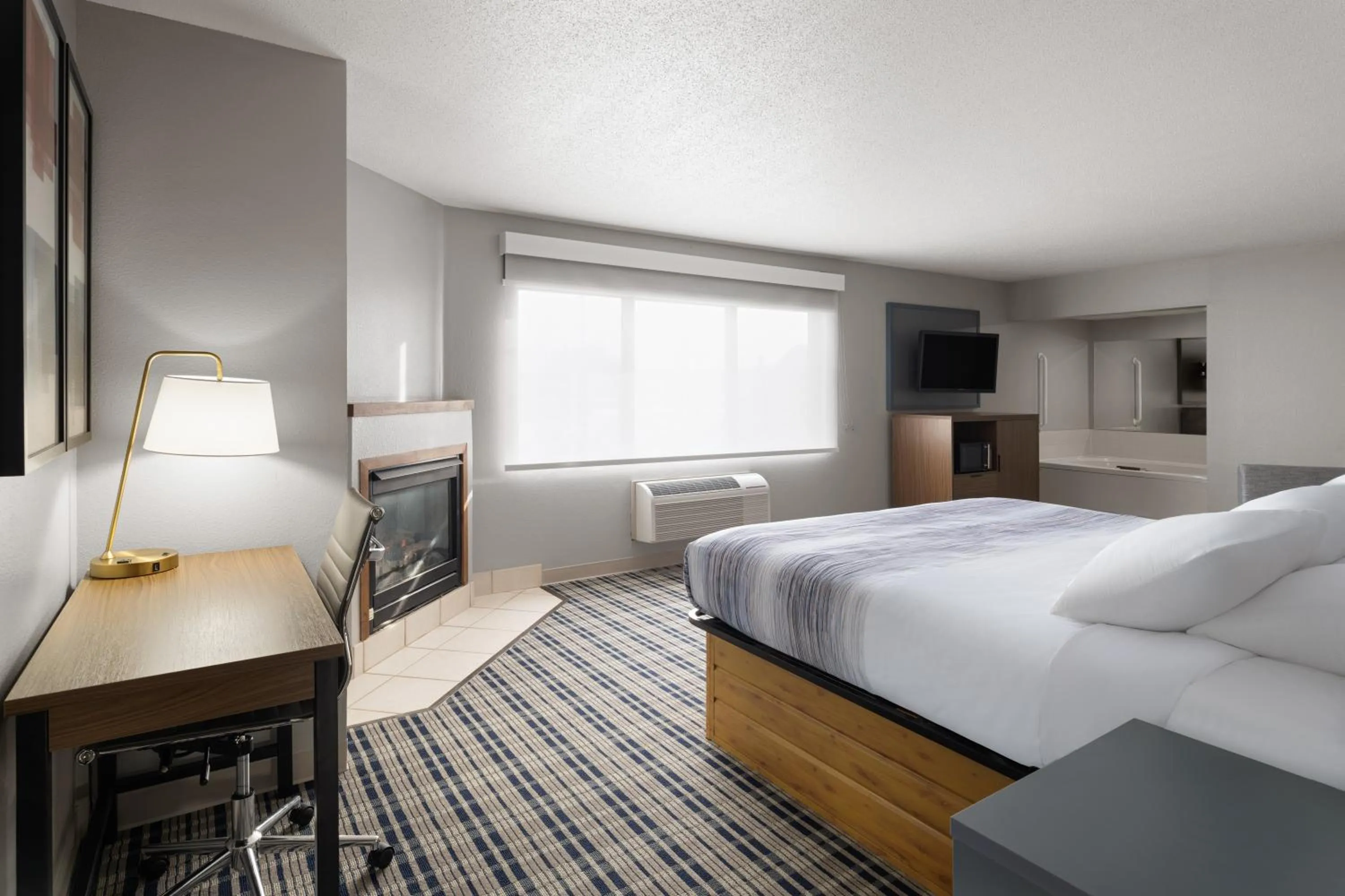 Bed in AmericInn by Wyndham Muscatine