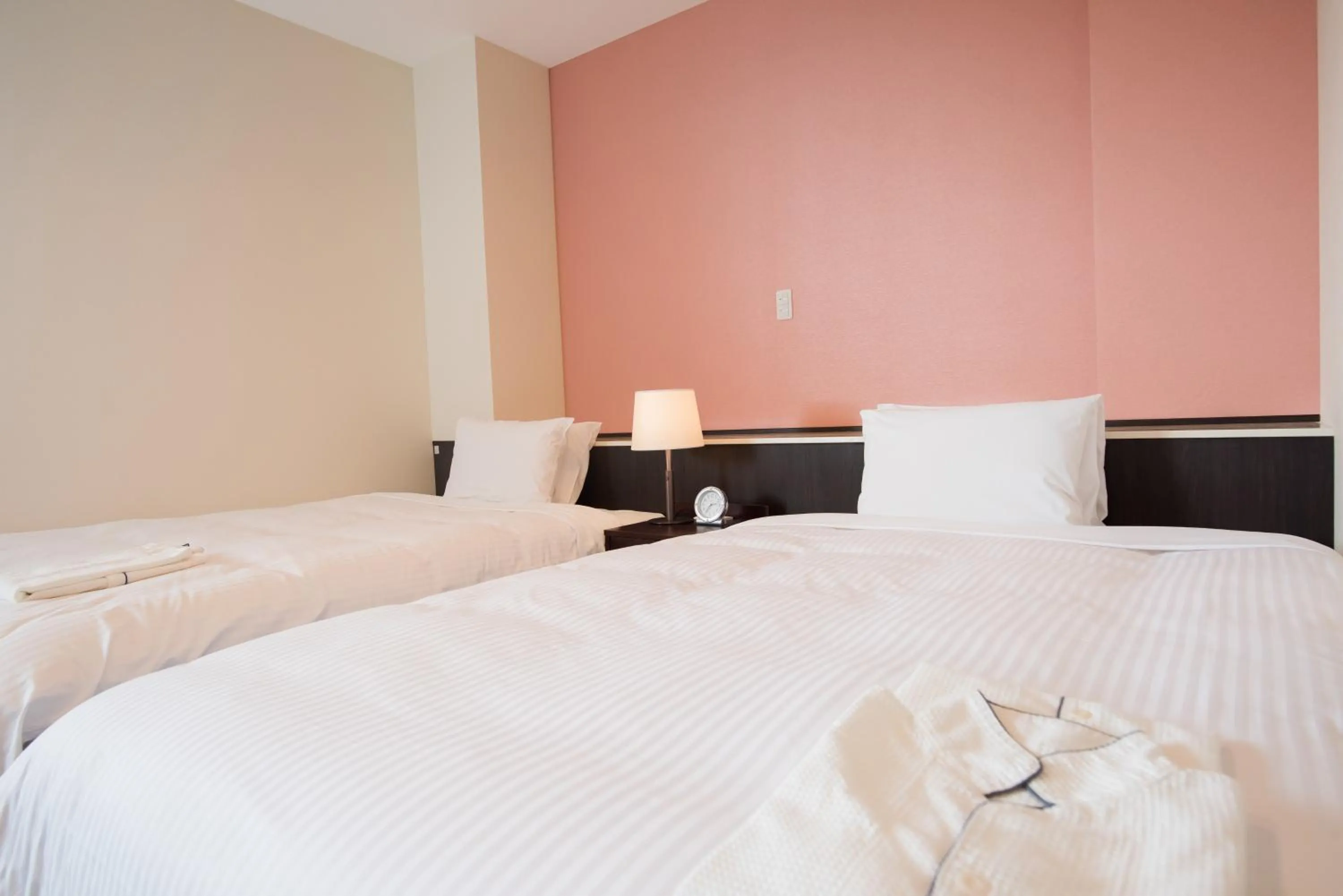 Bed in Crown Hotel Okinawa Annex