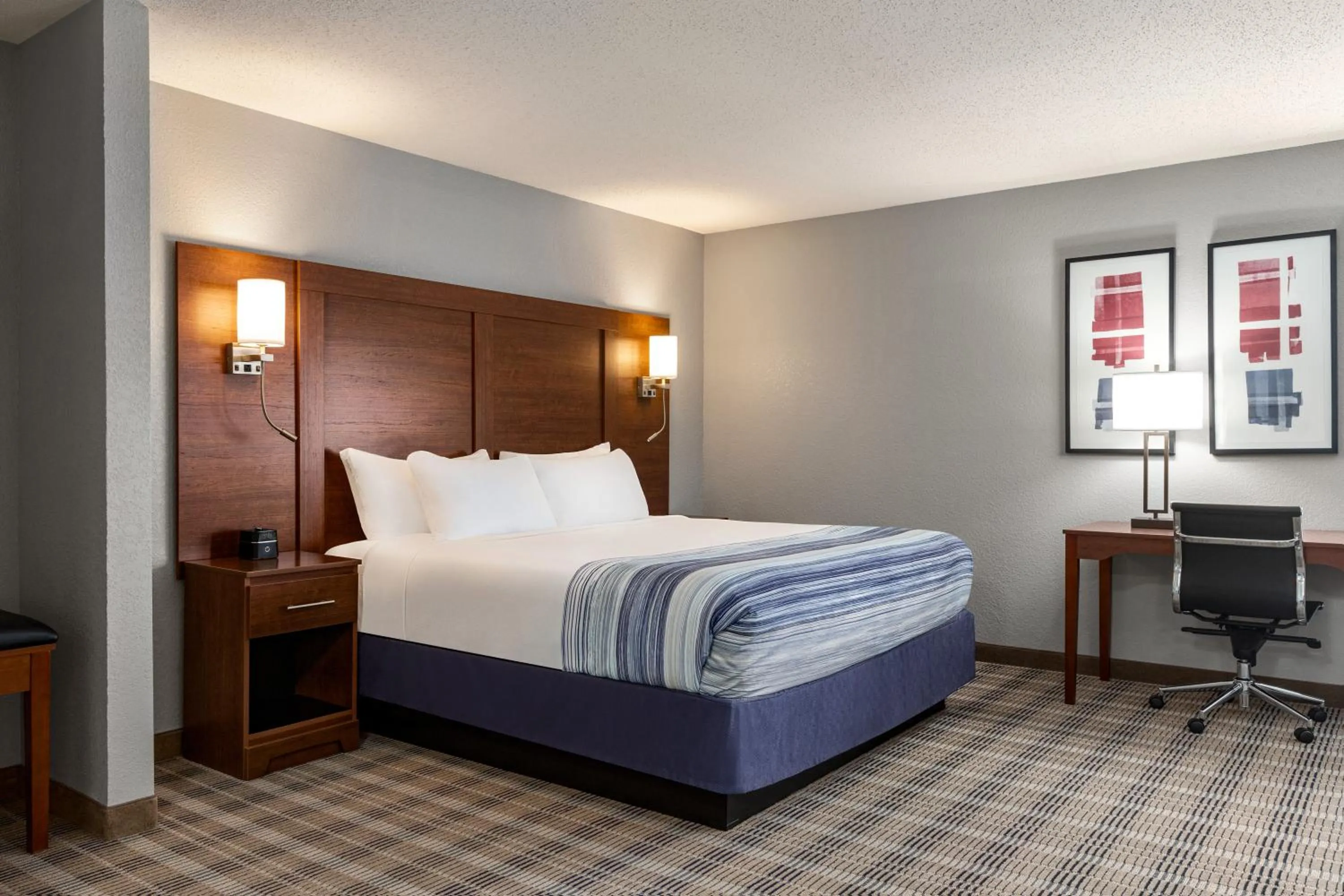 Bed in AmericInn by Wyndham Williamsburg