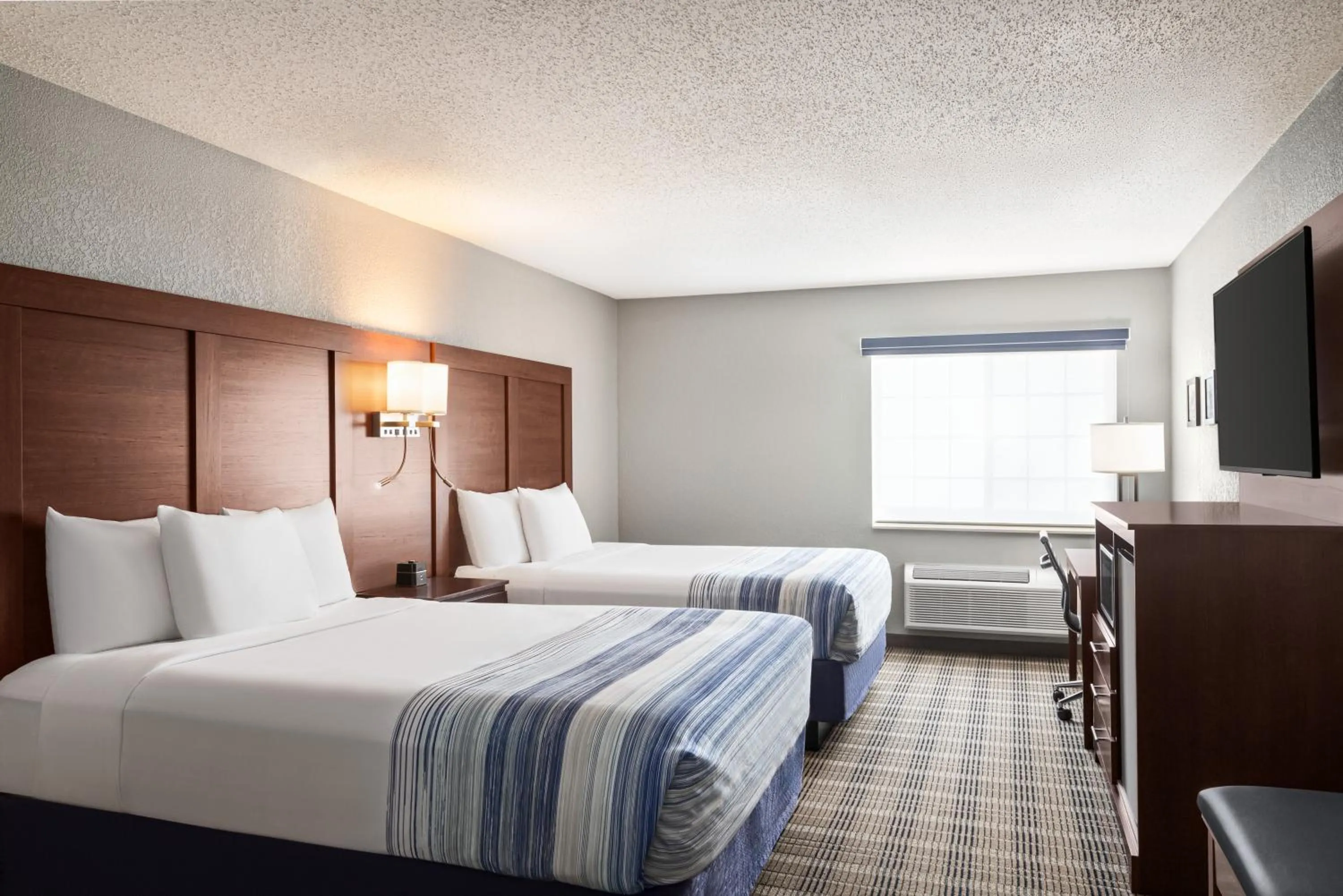 Bed in AmericInn by Wyndham Williamsburg