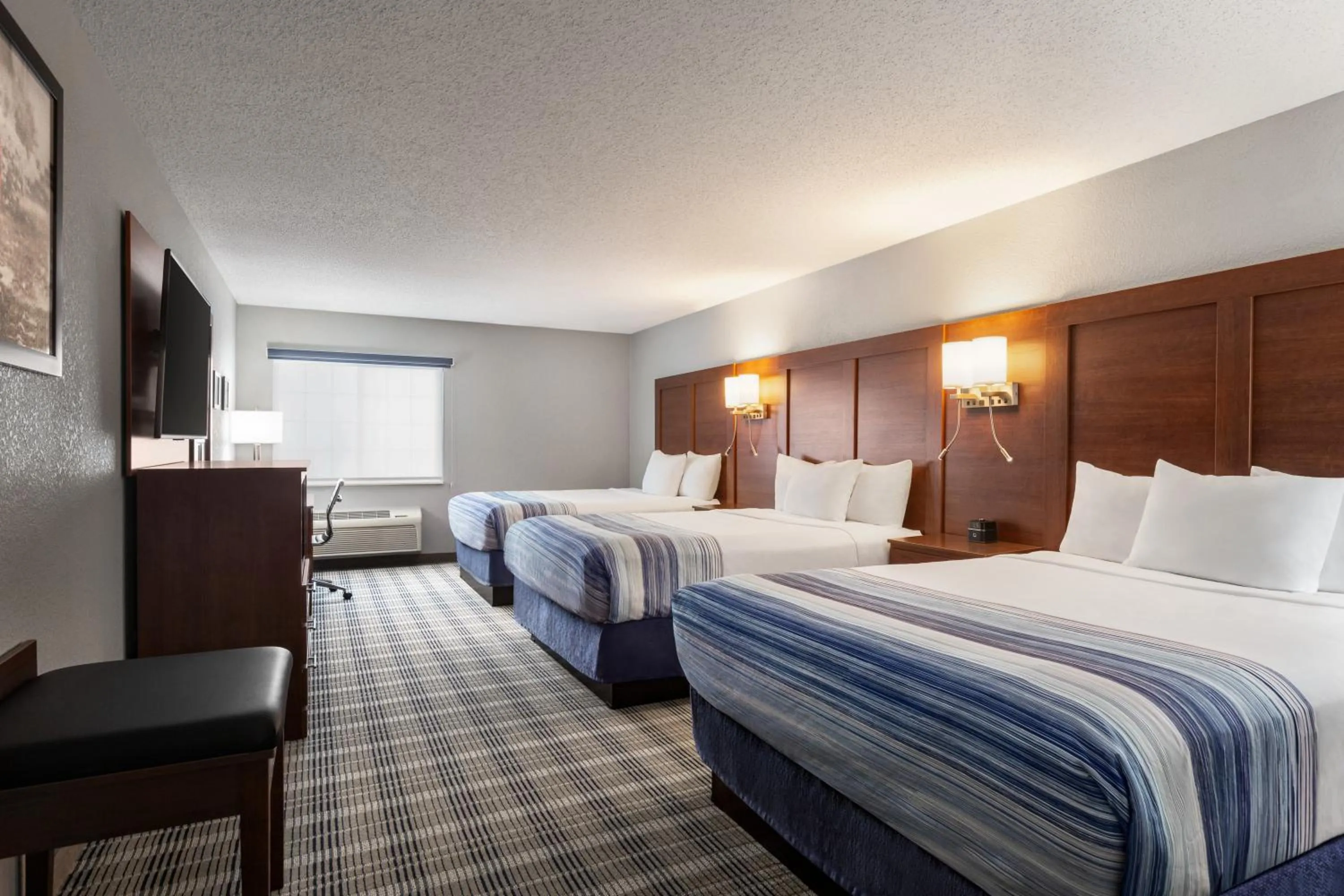 Bed in AmericInn by Wyndham Williamsburg