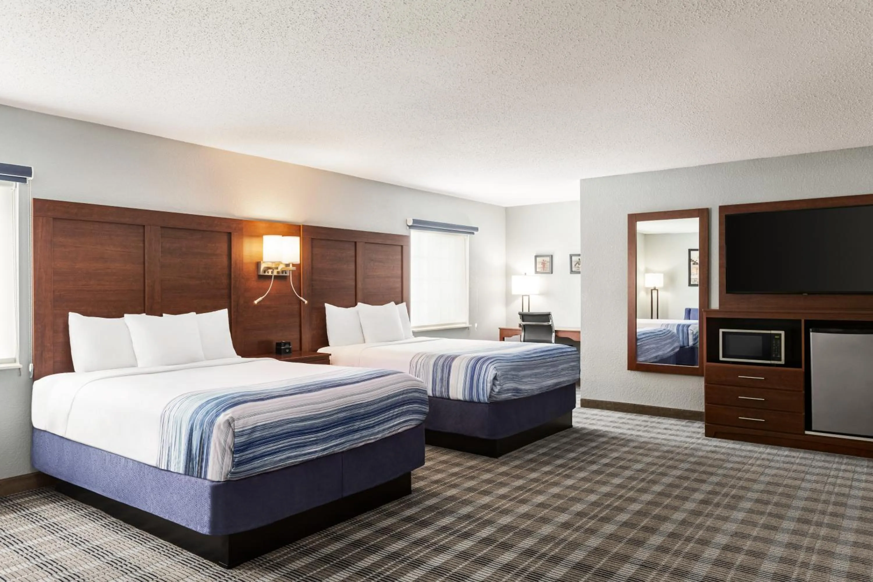 Bed in AmericInn by Wyndham Williamsburg