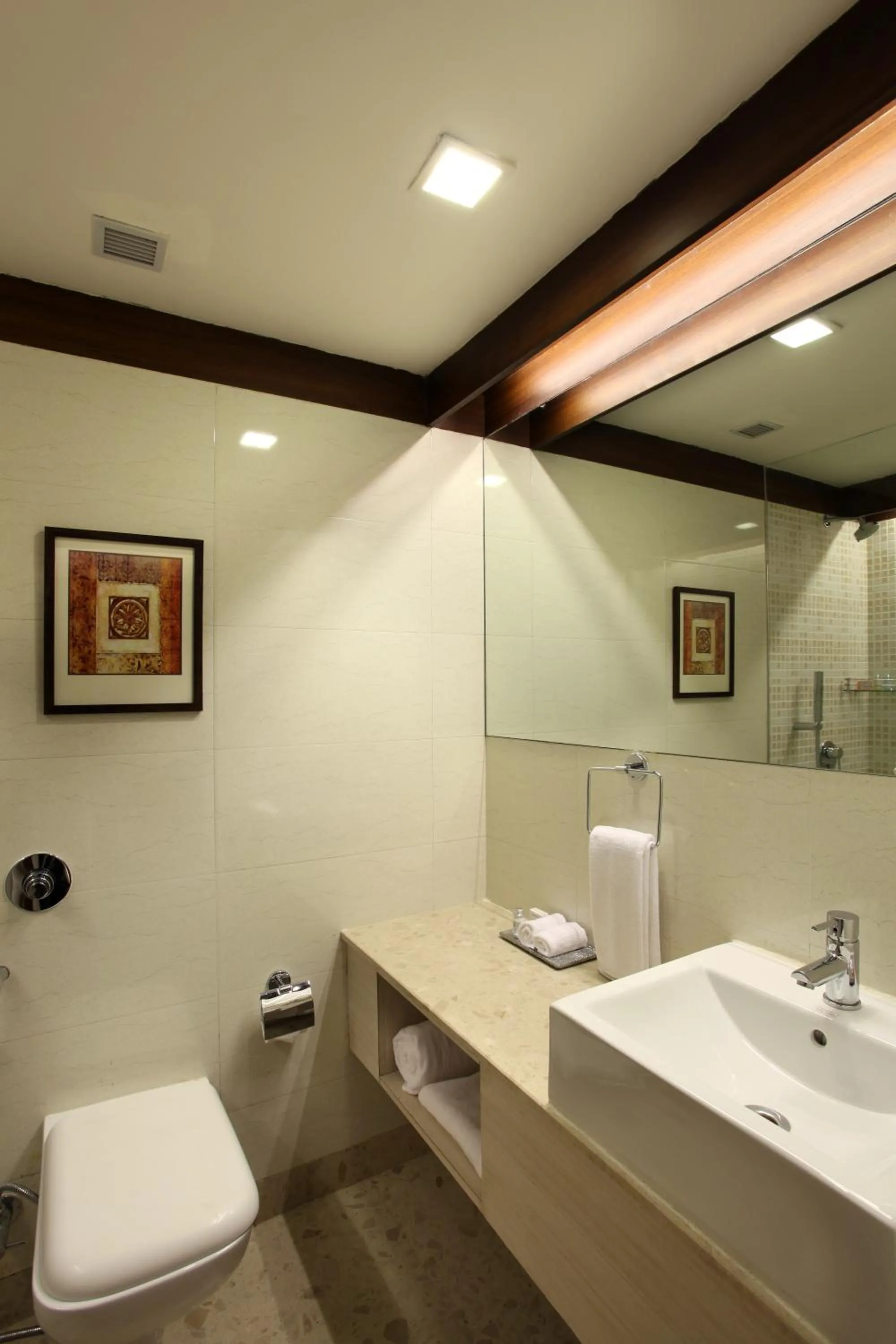 Toilet in Mahagun Sarovar Portico Suites