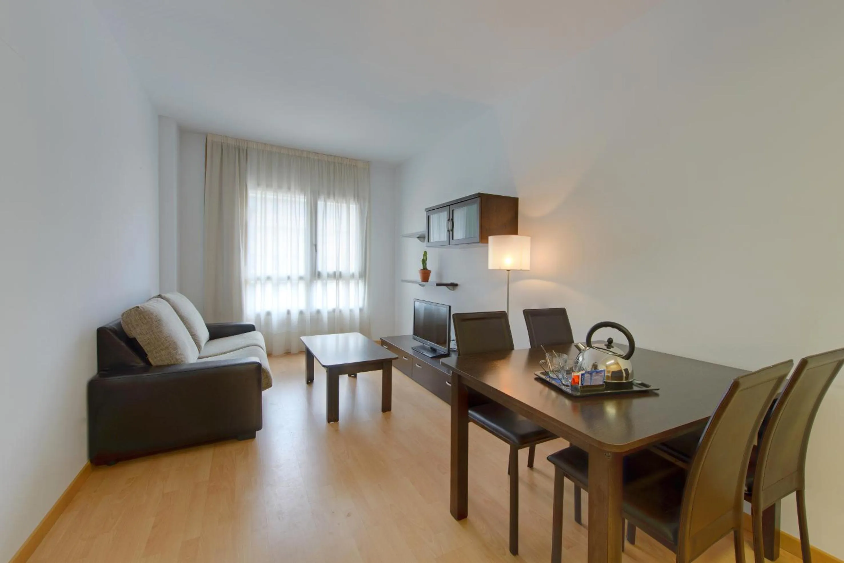 Living room in Madrid Airport Suites, Affiliated by Meliá