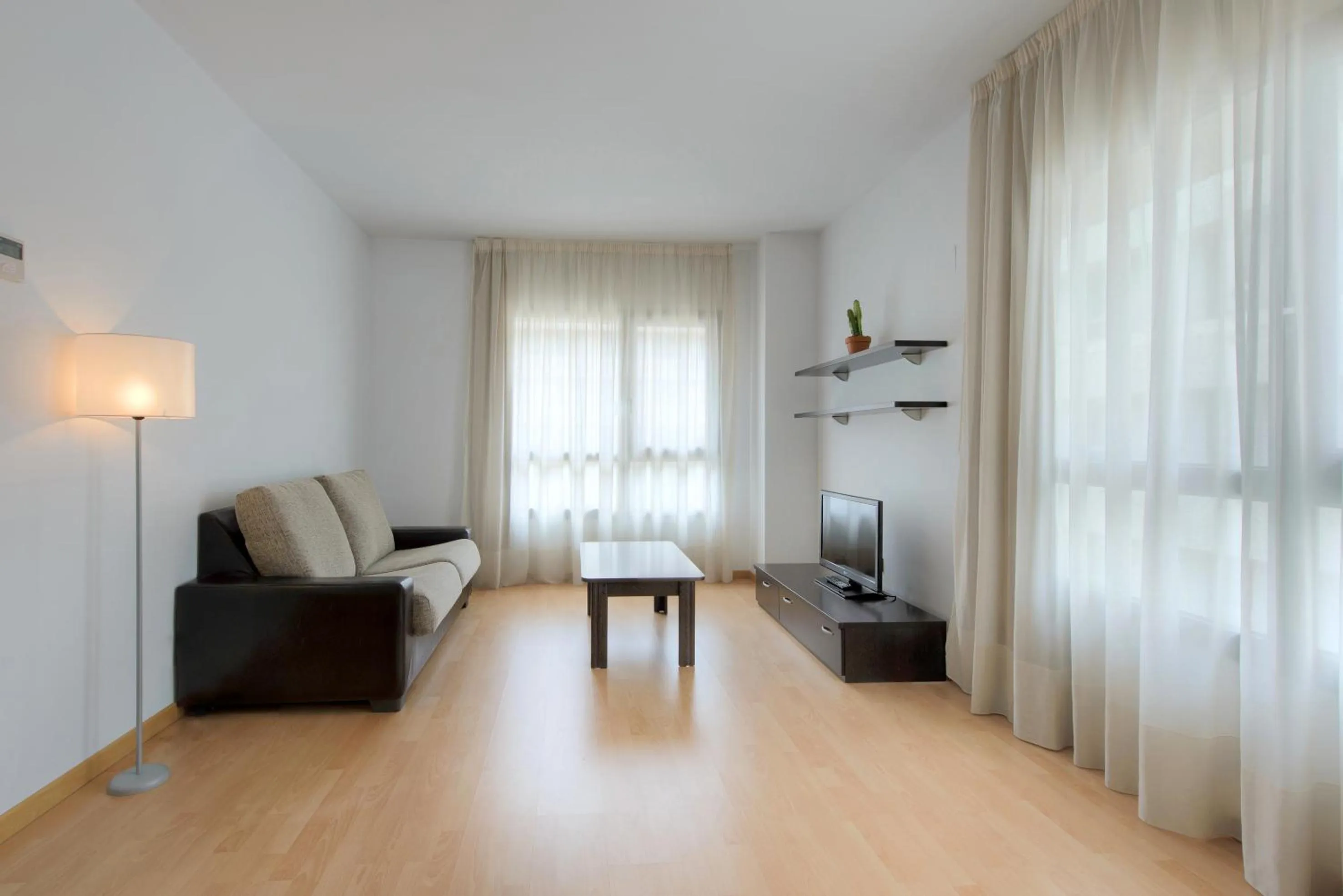 Living room in Madrid Airport Suites, Affiliated by Meliá