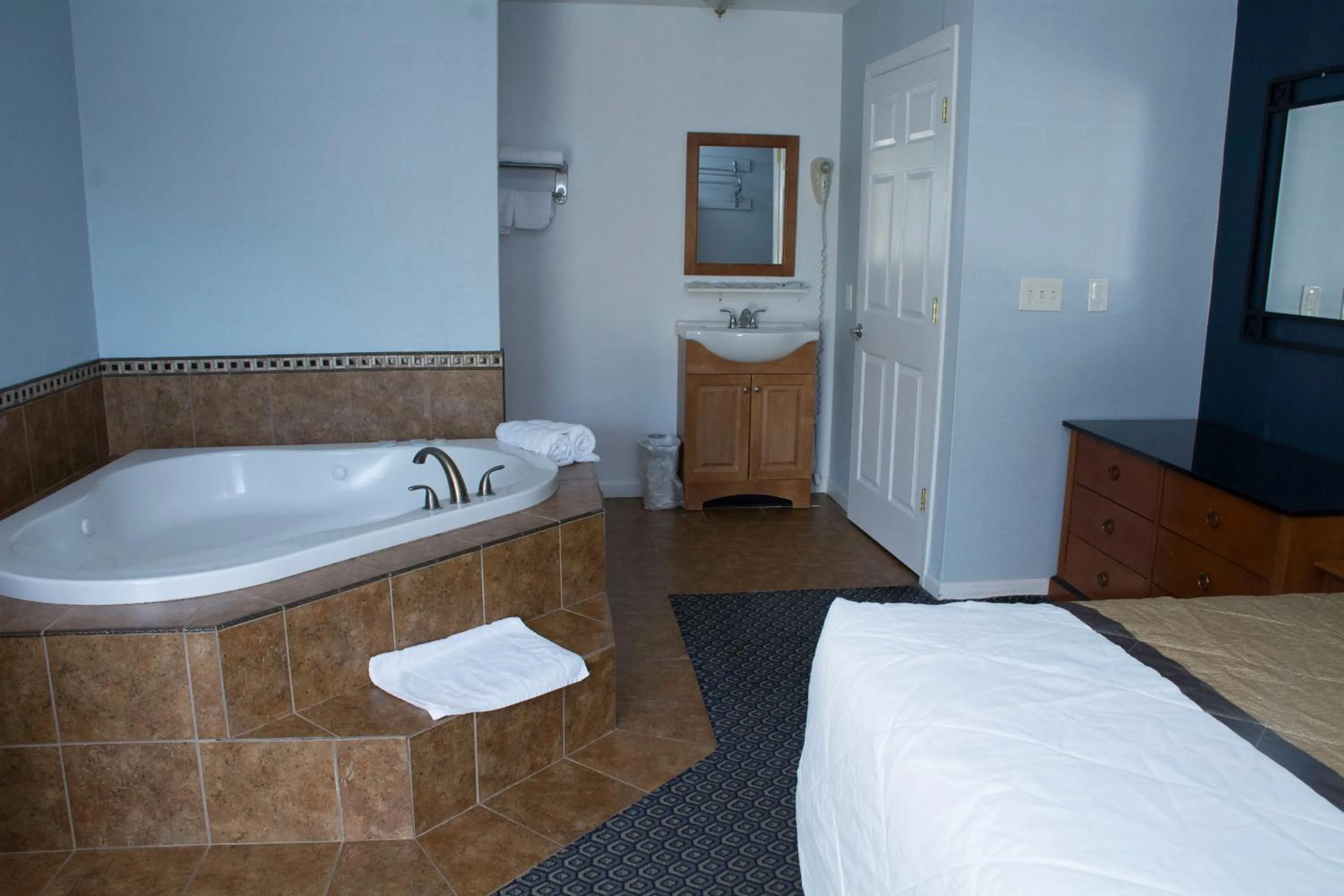Bathroom, Bed in At 9 Motel