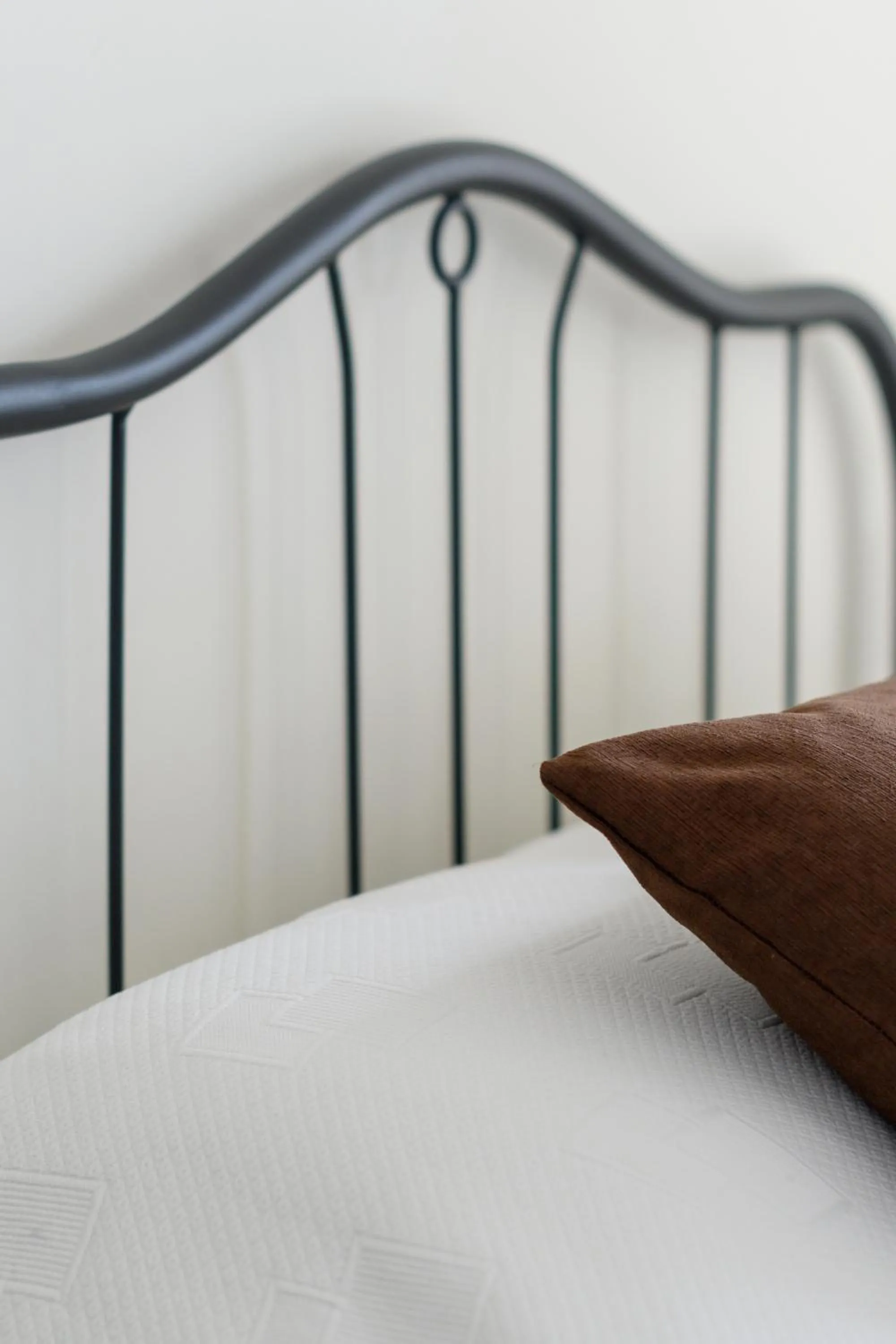 Bed in Moonlight Apartments & Suites