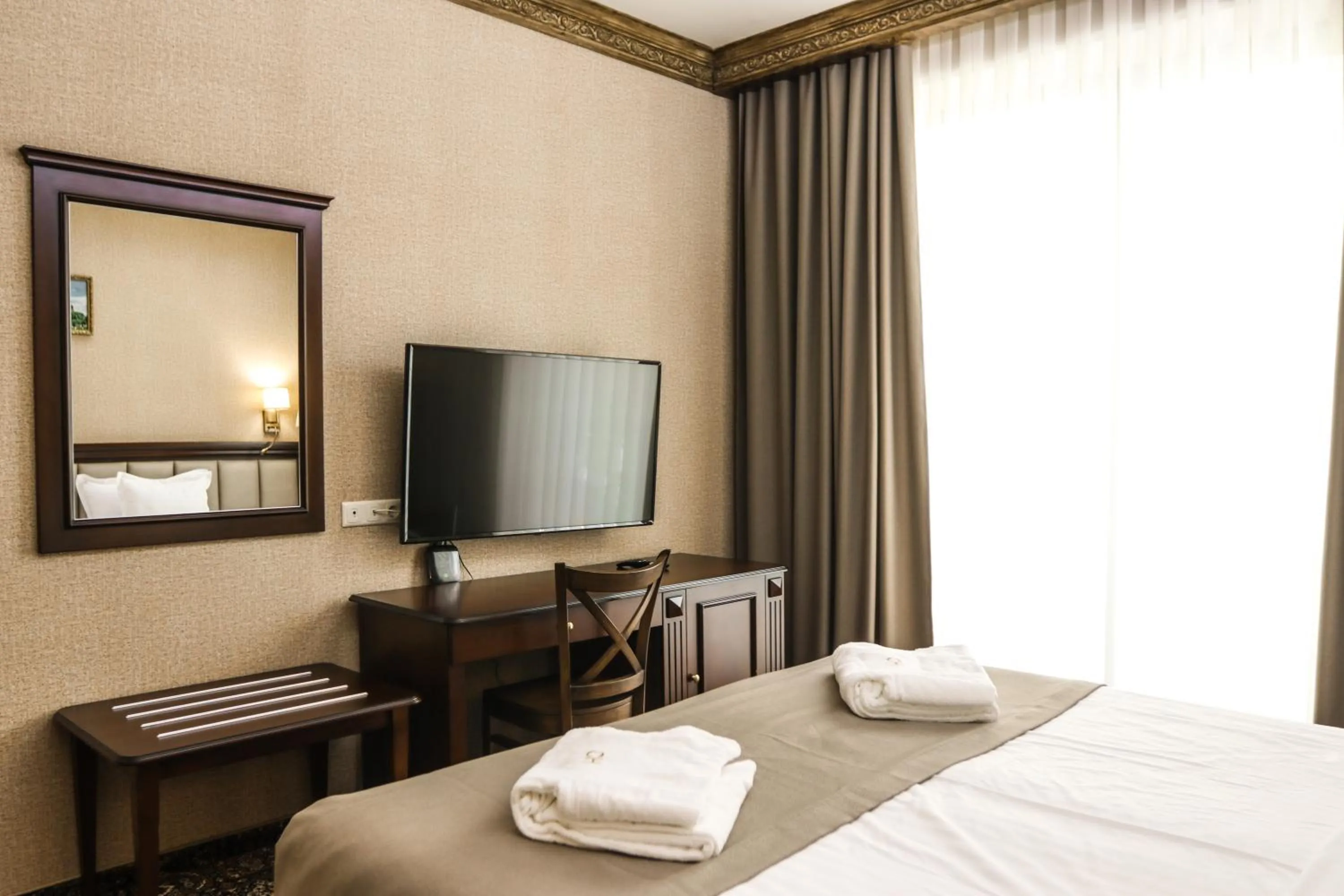 Communal lounge/ TV room, Bed in Konyak Hotel