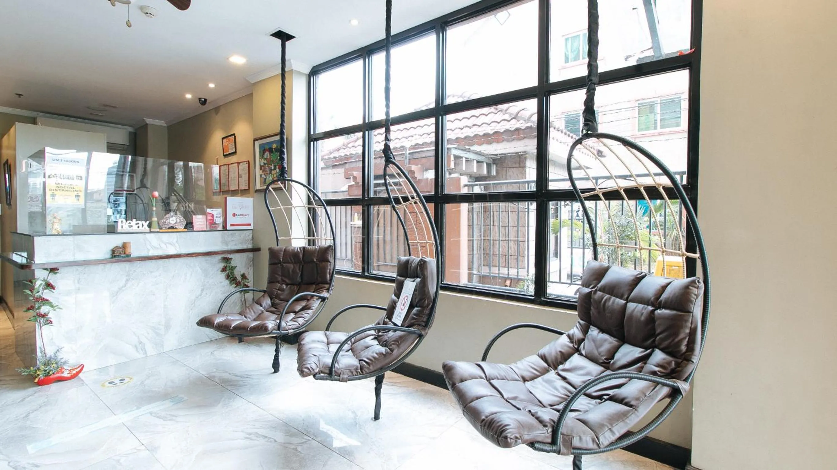 Seating area in RedDoorz Plus at MM Hotel Las Pinas former RedDoorz Plus Near Bamboo Organ