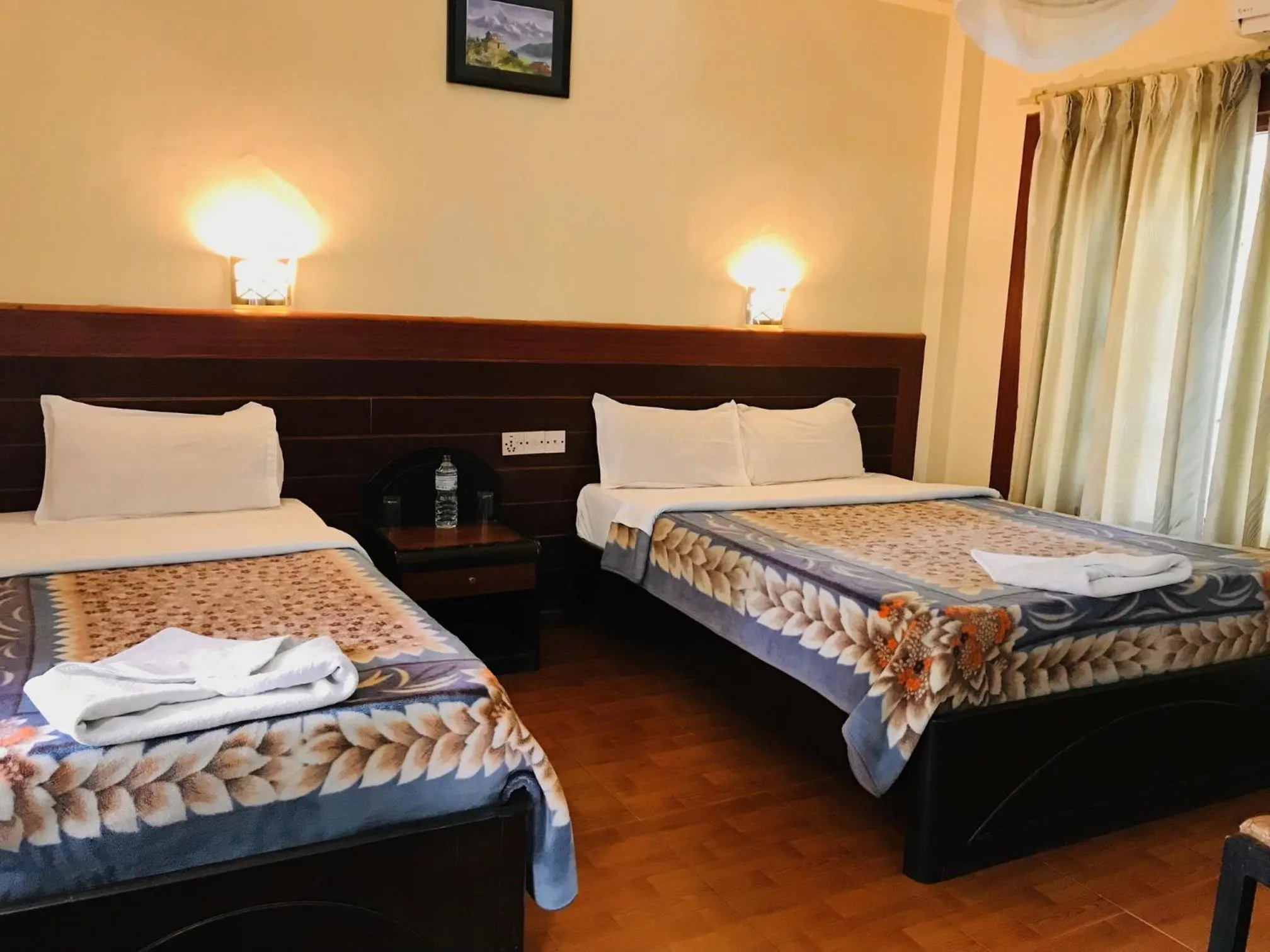 Bed in Chitwan Village Resort