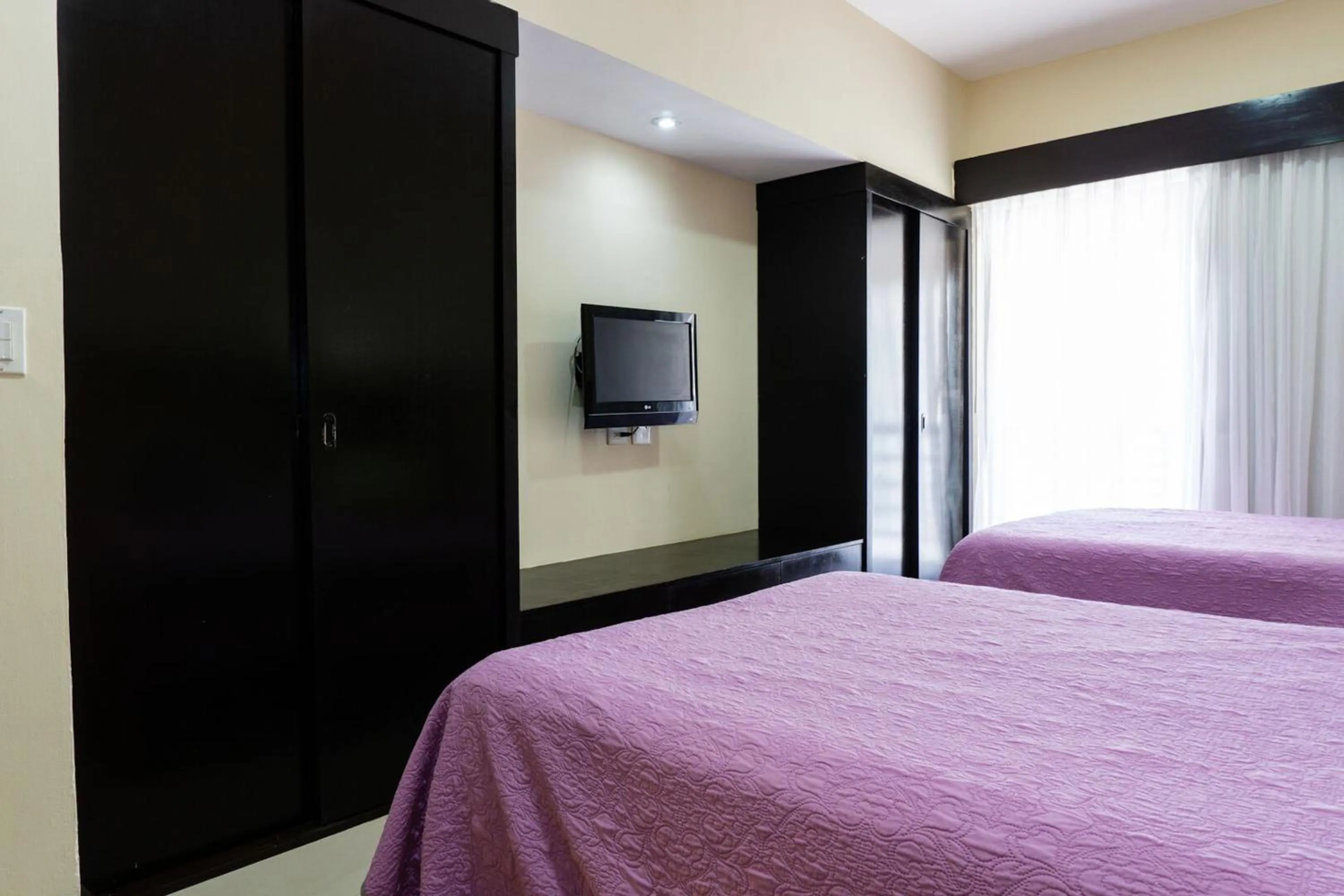 Bed in Aldea Beachside Condo by BVR