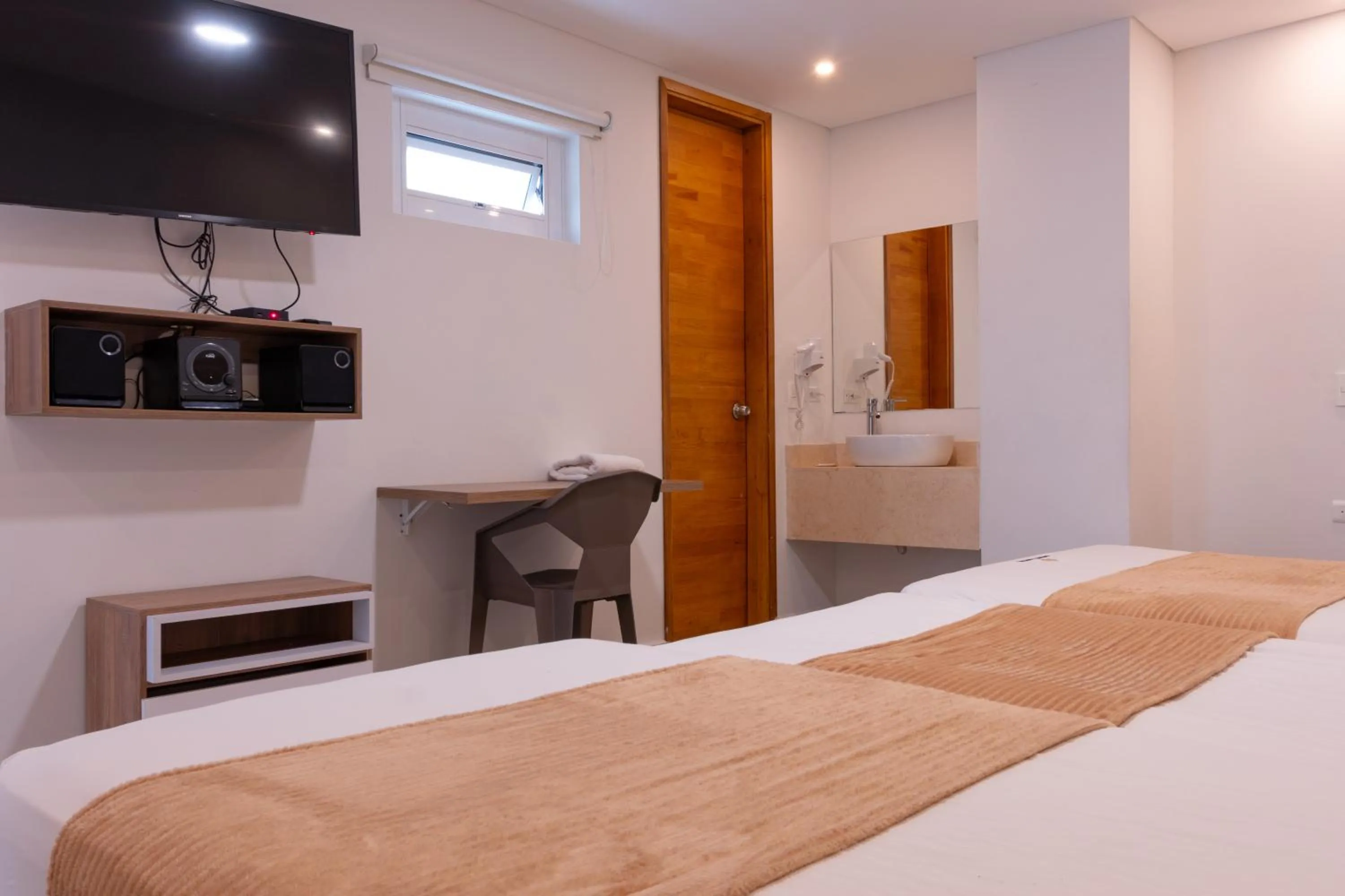 Communal lounge/ TV room, Bed in Infinity Hotel