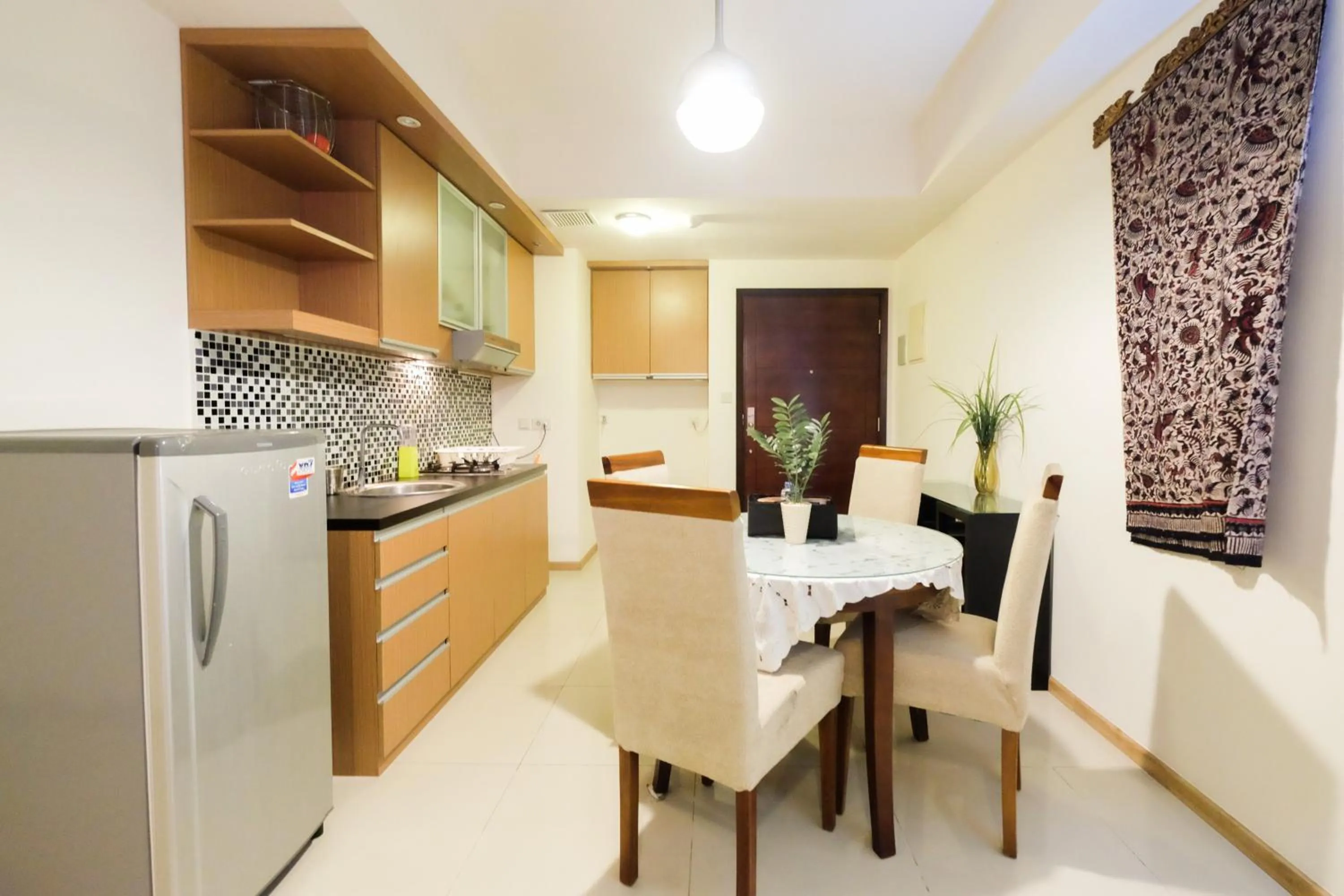 Dining area in Homey 2BR Apartment at Casa Grande Residence By Travelio