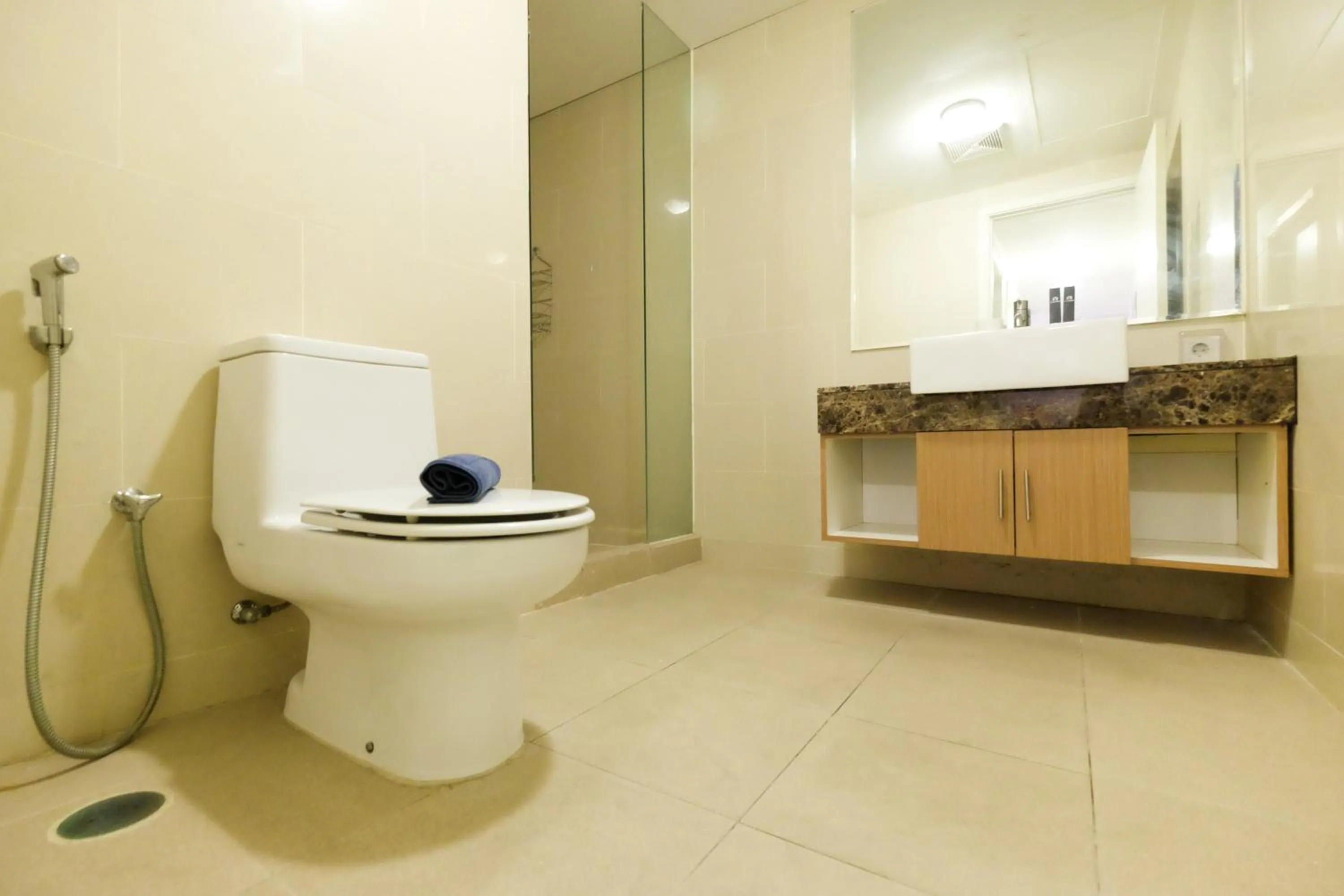 Bathroom in Homey 2BR Apartment at Casa Grande Residence By Travelio