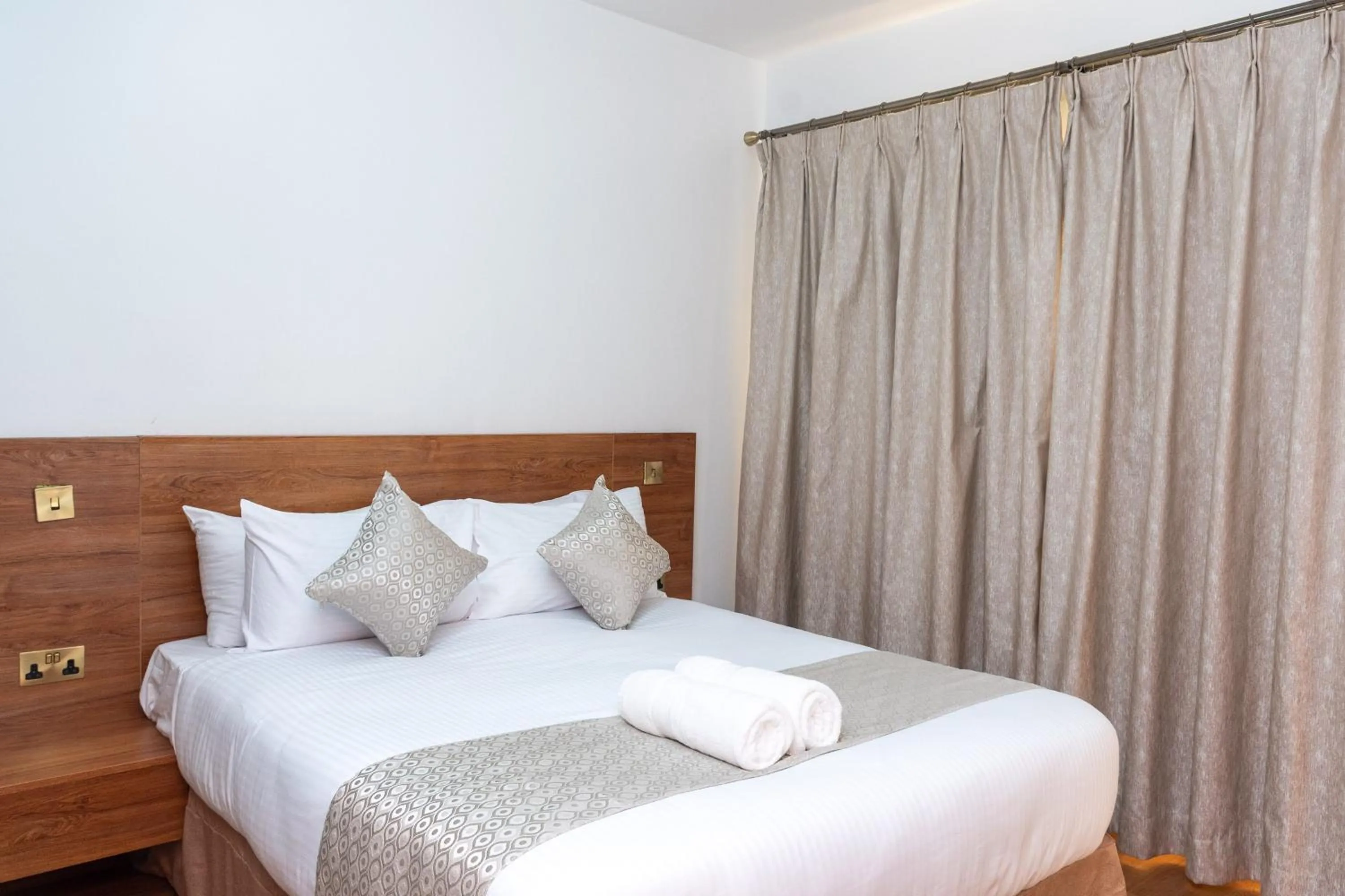 Bed in CySuites Apartment Hotel