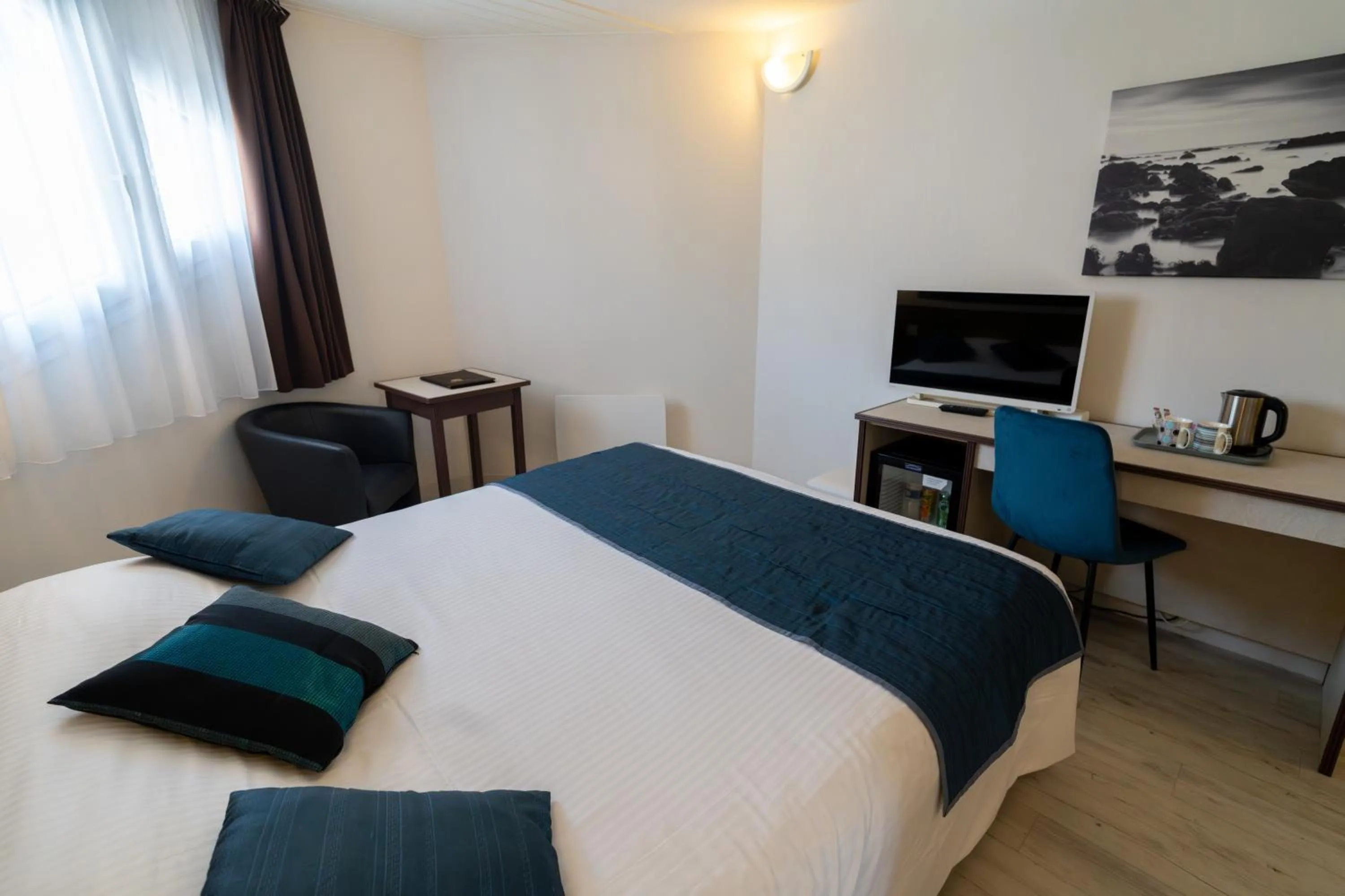 Bed in Logis Hotel Arc En Ciel