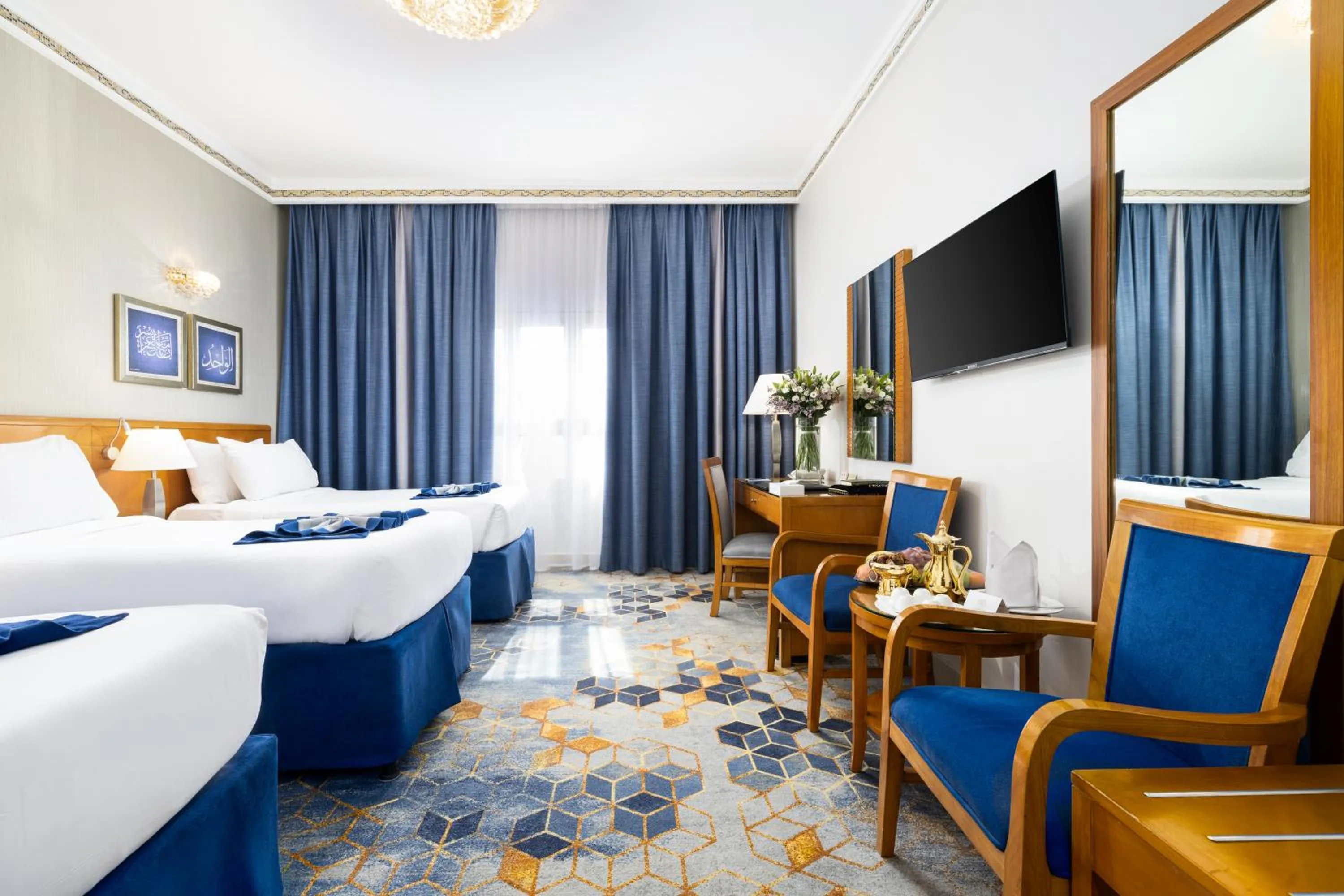 Communal lounge/ TV room, Bed in Emaar Grand Hotel