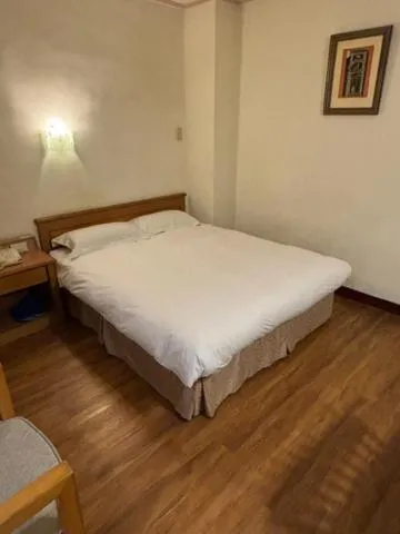 Bed in 金馬大飯店 Riverside Hotel