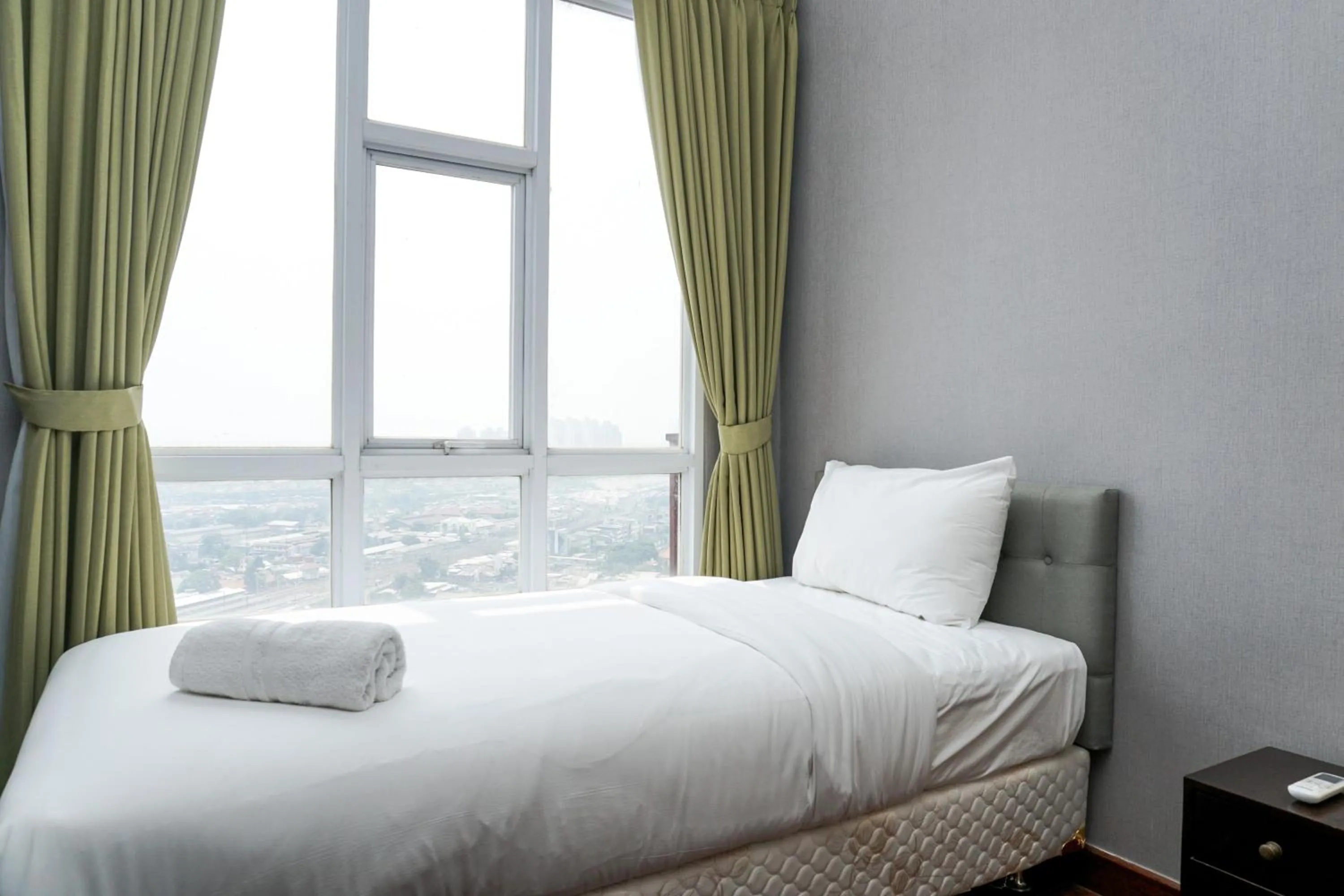 Bed in Fabulous 2BR Apartment Lucky Tower Residence By Travelio