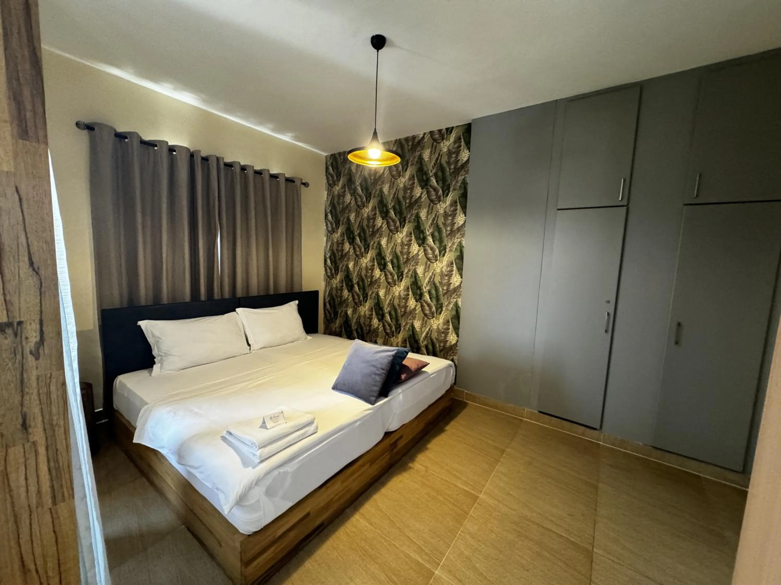 Bed in Roots Hotel Apartment