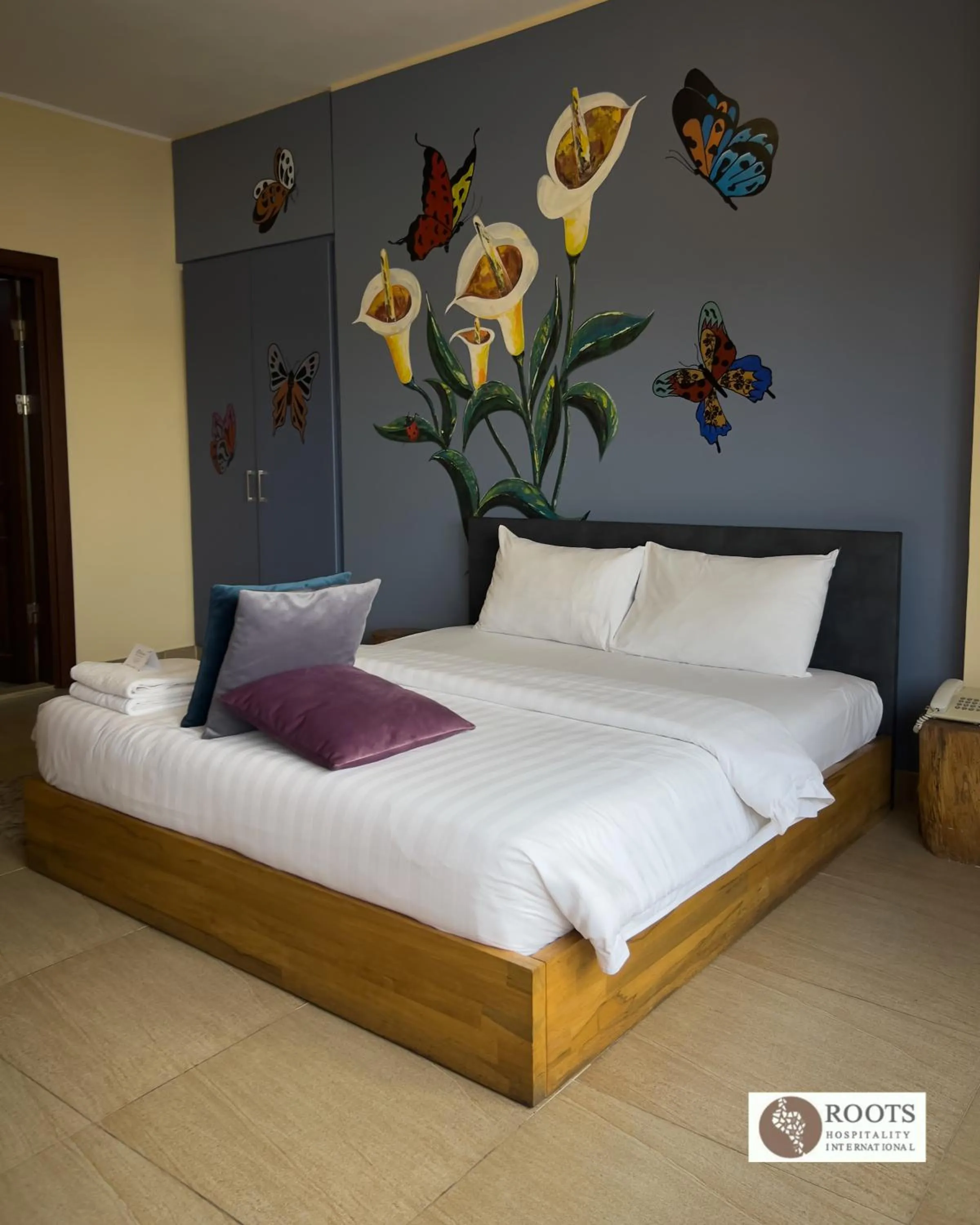 Bed in Roots Hotel Apartment