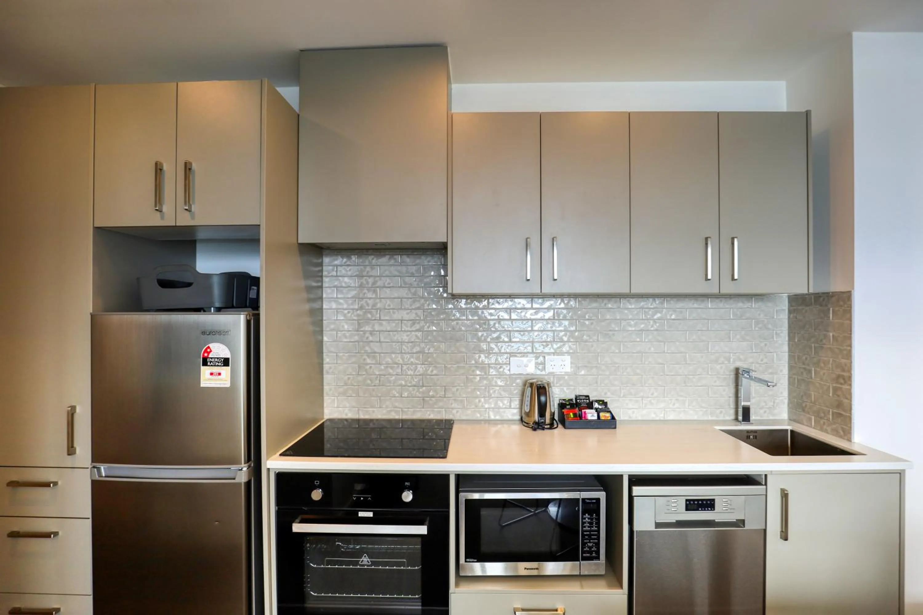 Kitchen or kitchenette in Ramada Suites By Wyndham Victoria Street West