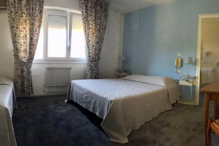 Bed in Logis Hotel du Midi