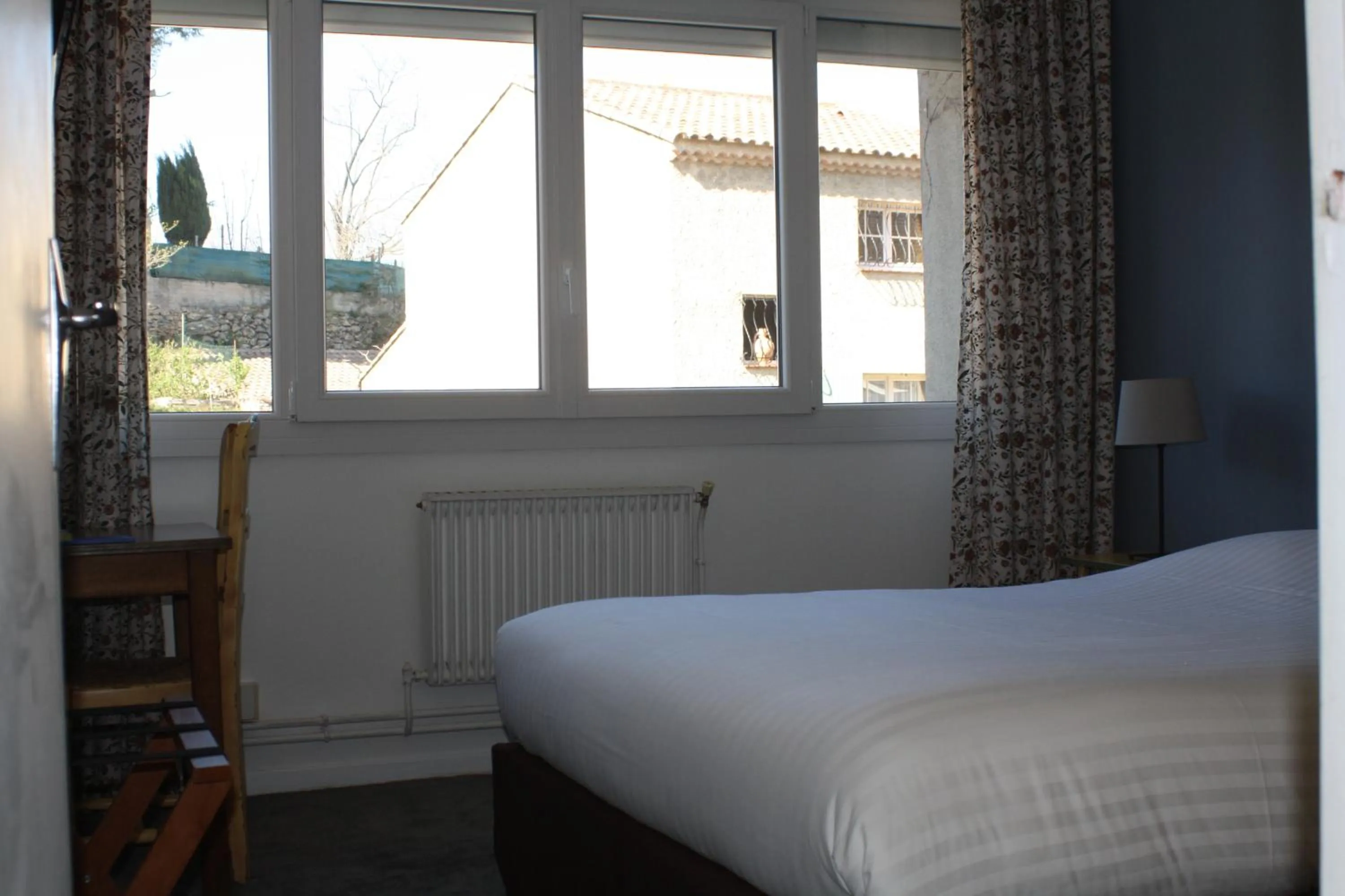 Bed in Logis Hotel du Midi