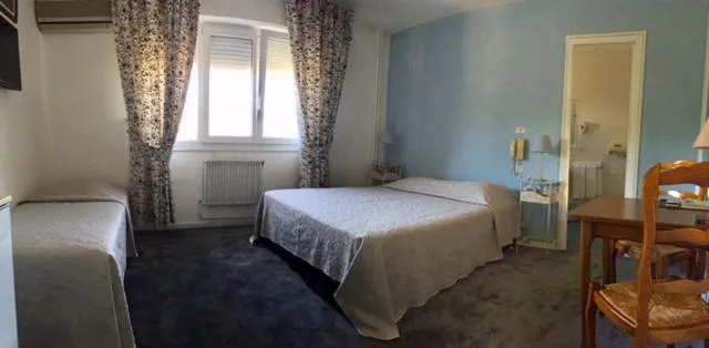 Bed in Logis Hotel du Midi