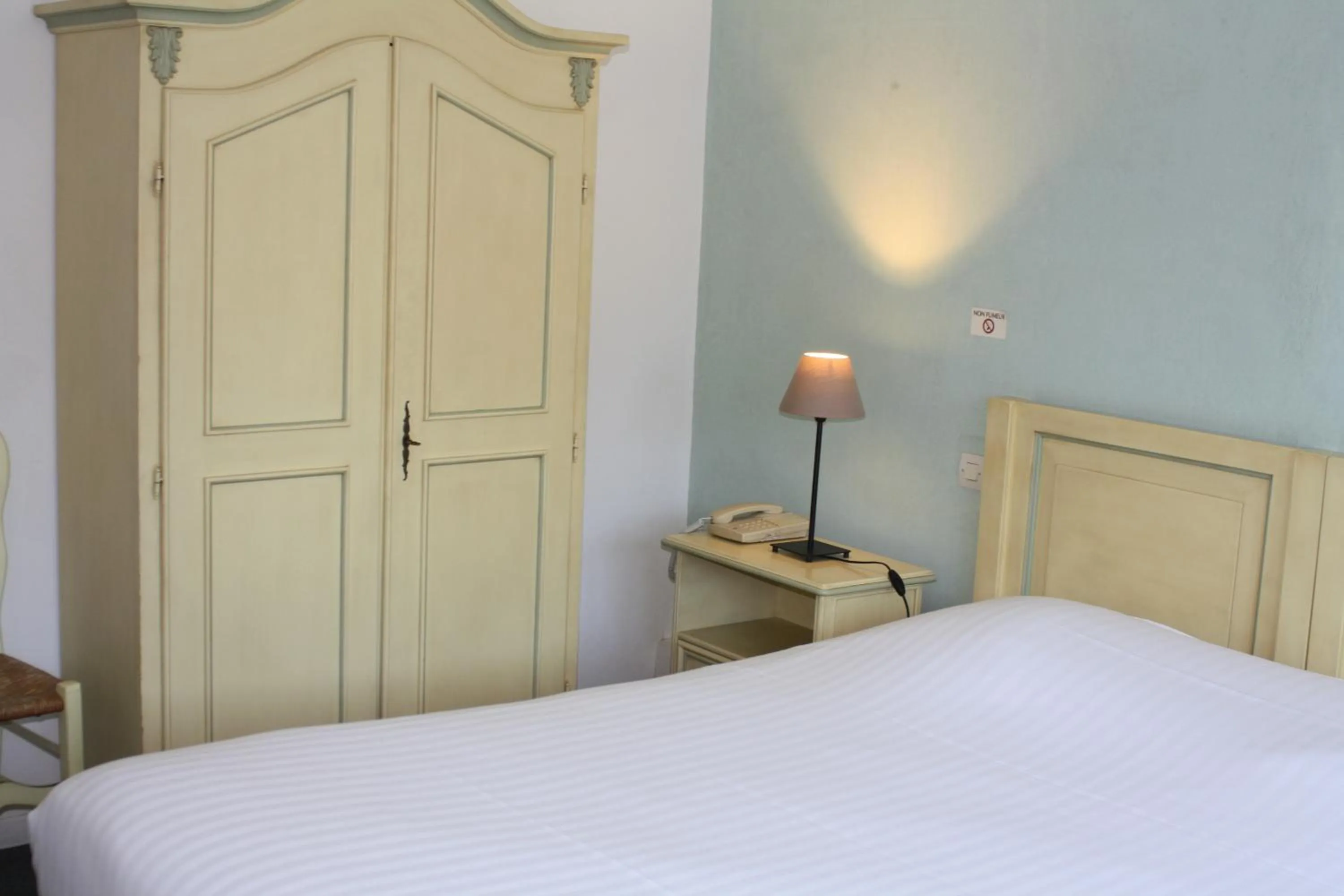 Bed in Logis Hotel du Midi