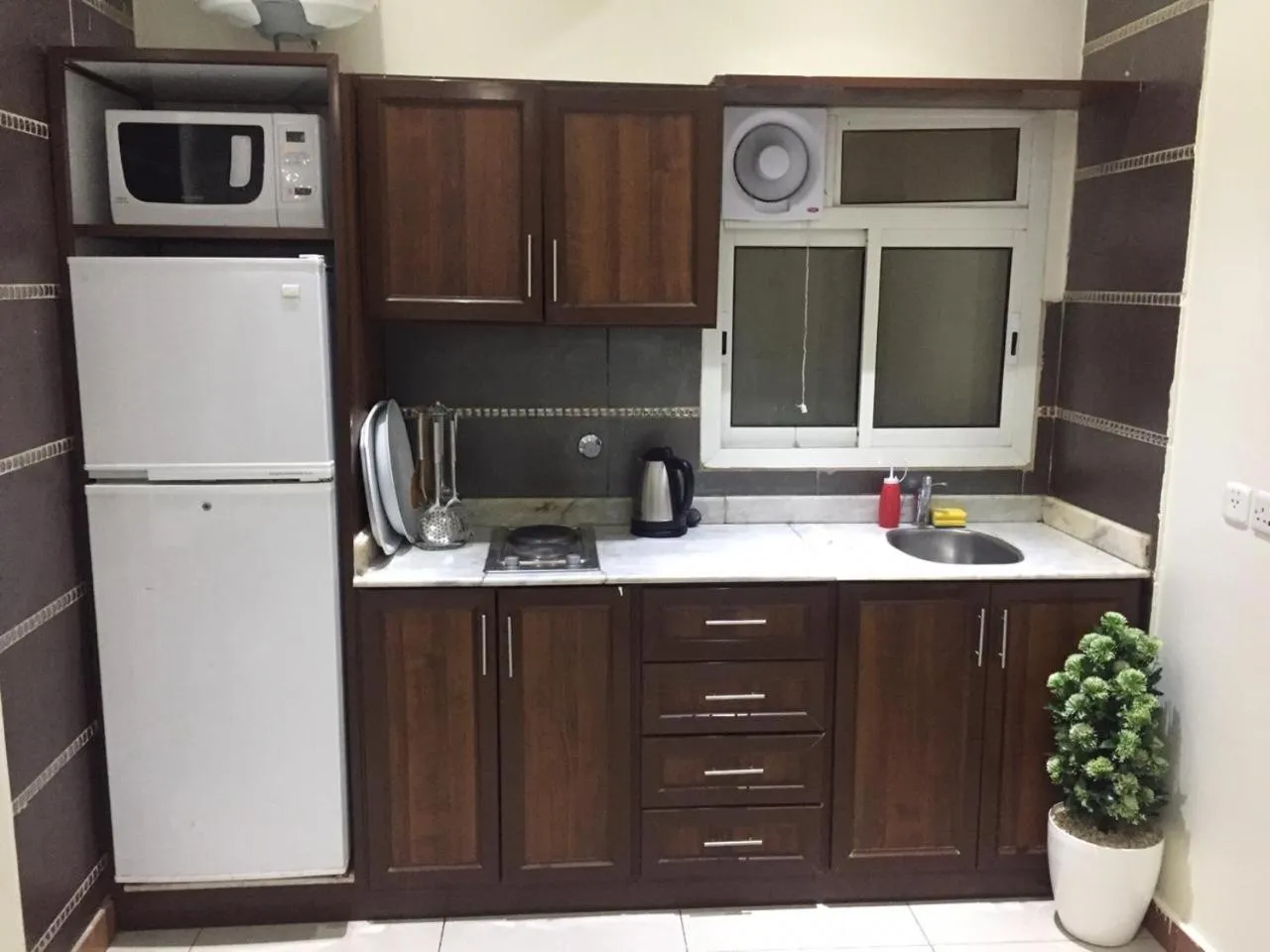 Kitchen or kitchenette in Merfal Hotel Apartments Al Taawan