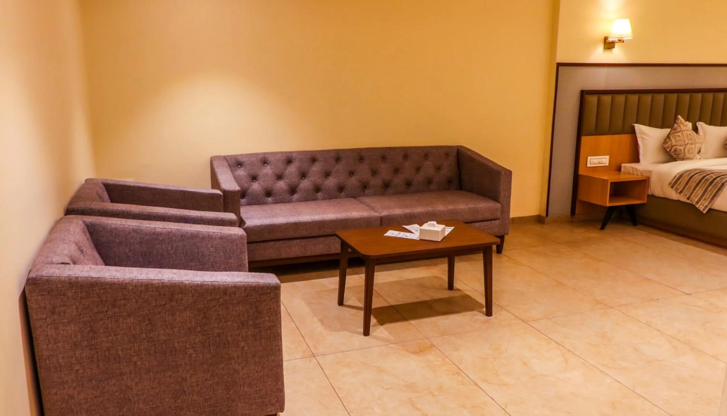 Seating area, Bed in Rudra Shelter Business Hotel