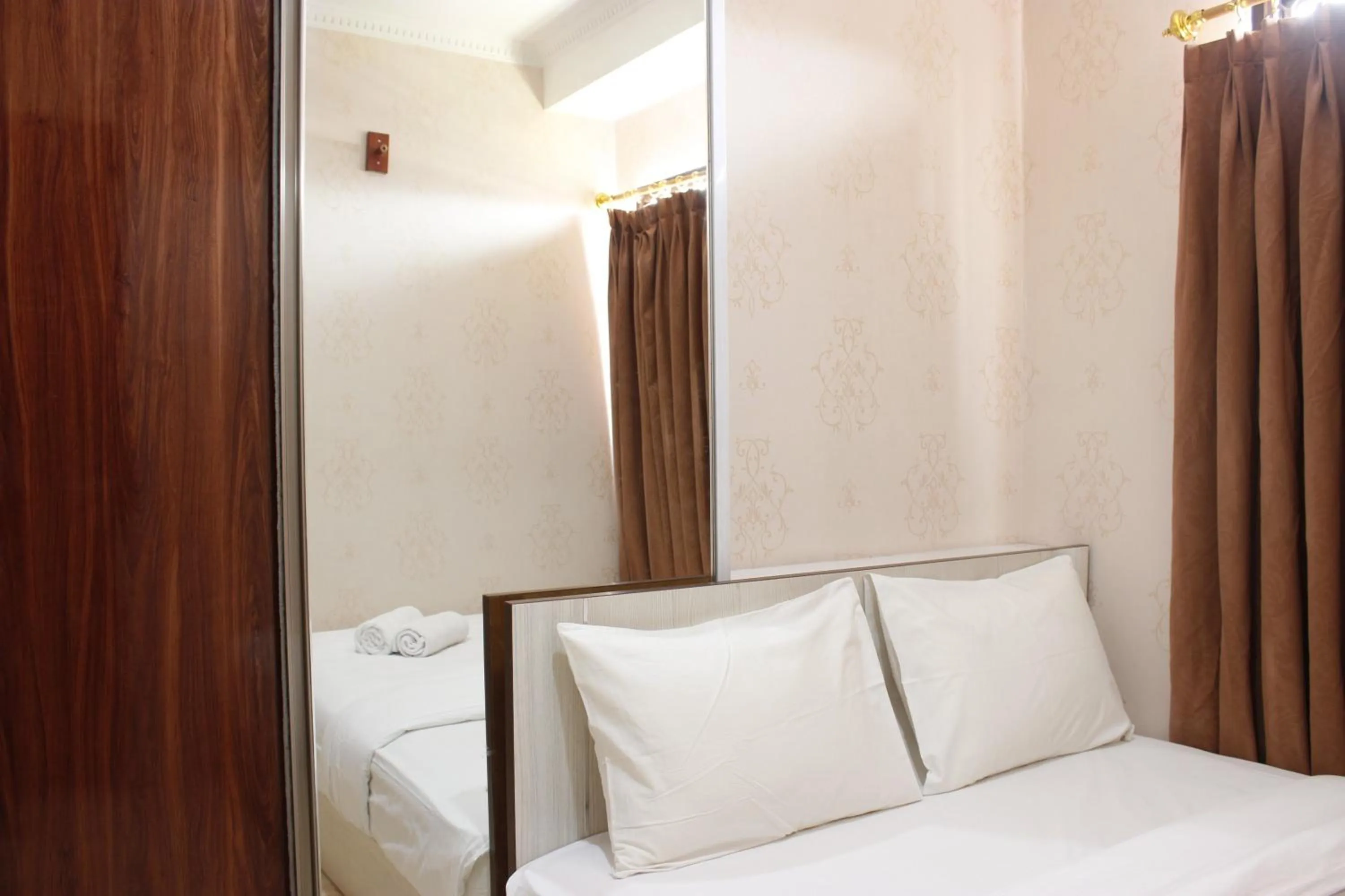 Bed in Cozy 2BR Tamansari Panoramic Apartment By Travelio