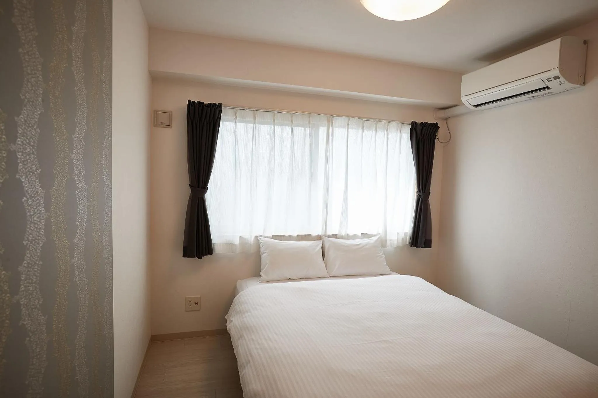 Bedroom, Bed in New Normal Hotel in NAGO ニューノーマルホテルイン名護