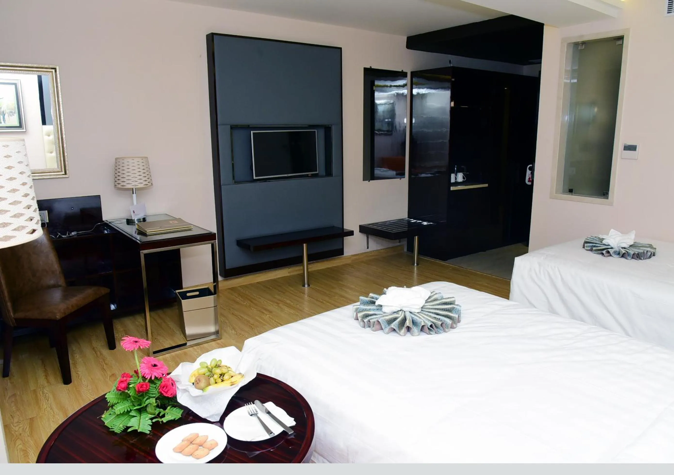 Communal lounge/ TV room, Bed in OM Clarks Inn Raebareli