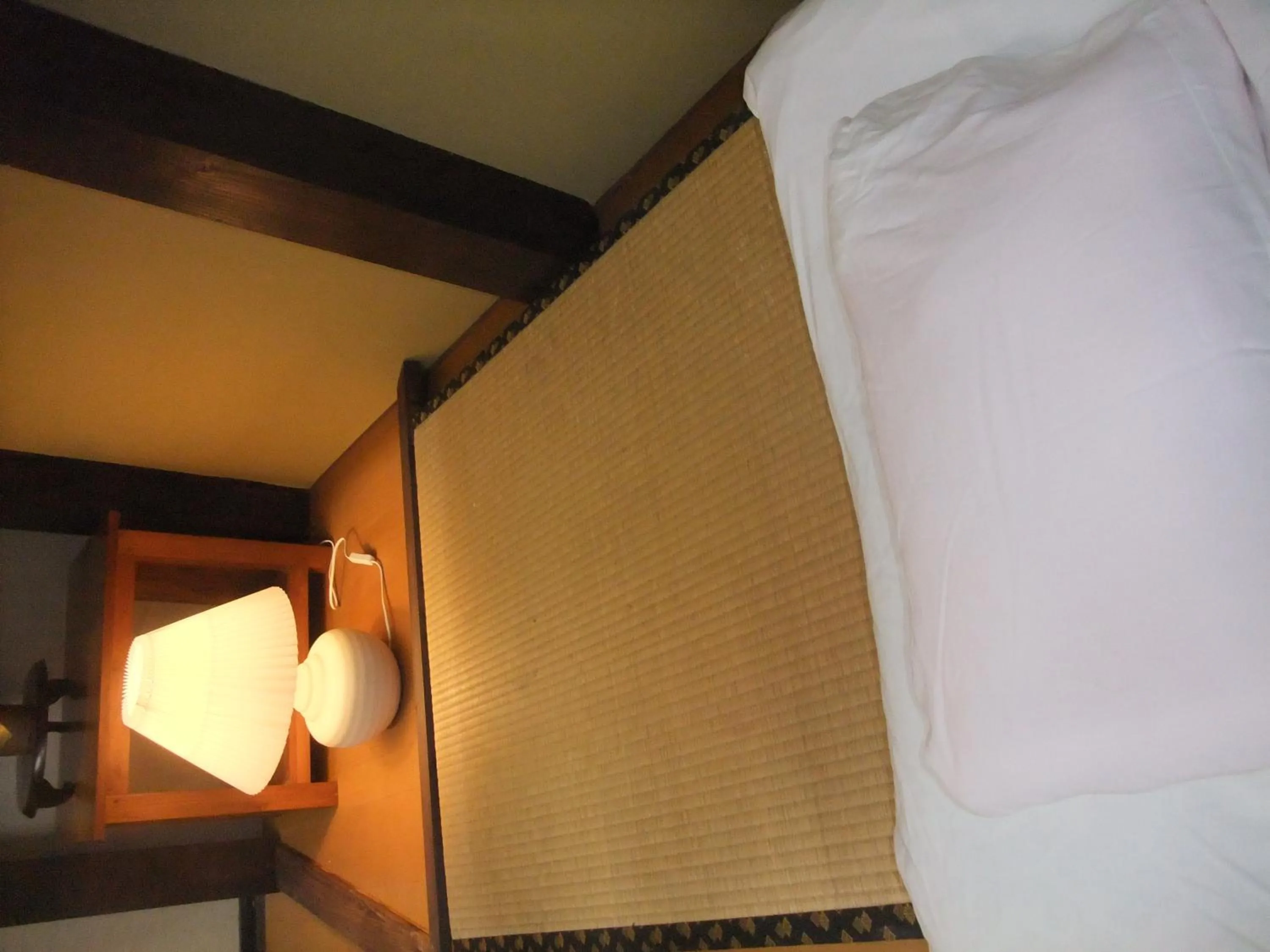 Bed in HAKUBA IKEDA LIFE KAN APARTMENTS