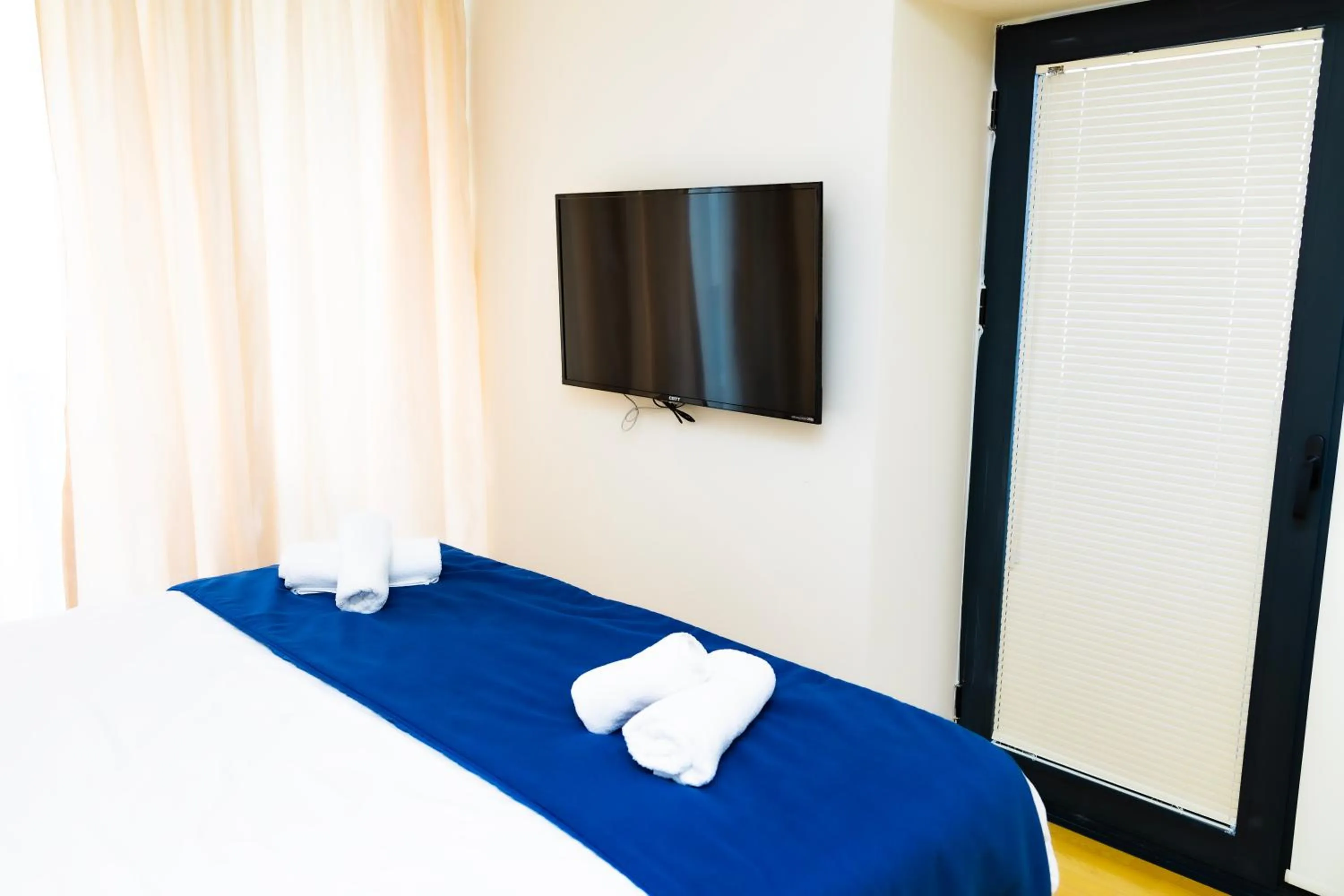 Communal lounge/ TV room, Bed in Orbi City Inn