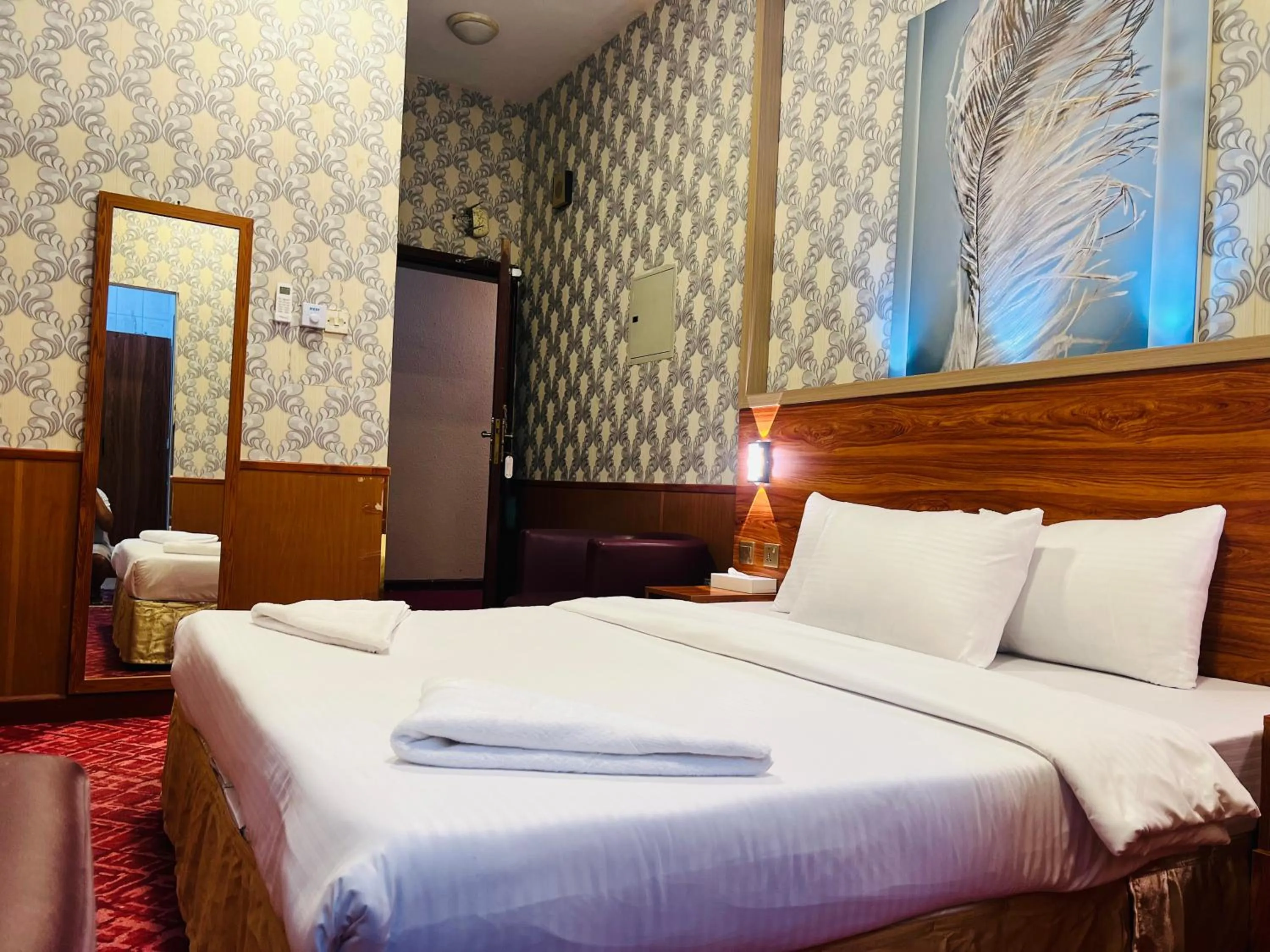 Bed in Parasol Hotel