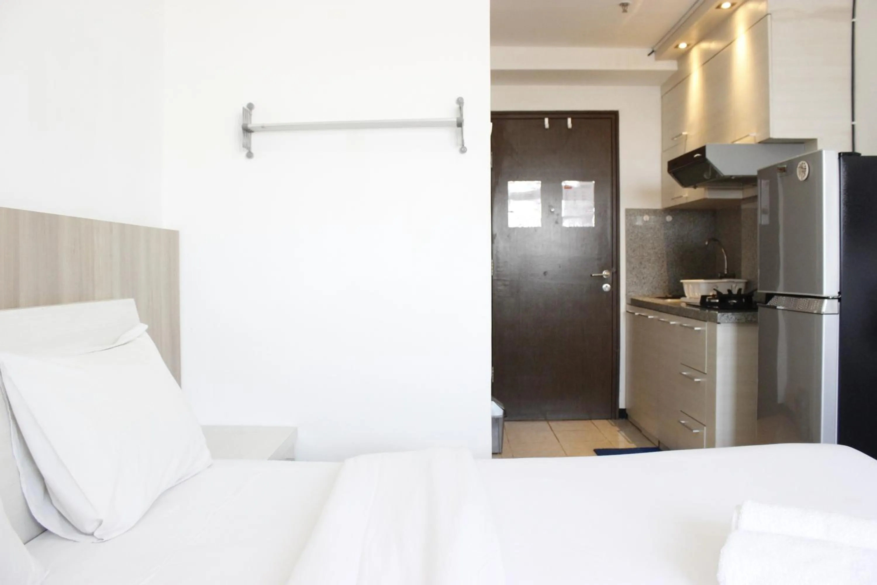 Bed in Minimalist Studio Apartment at The Suite @Metro By Travelio