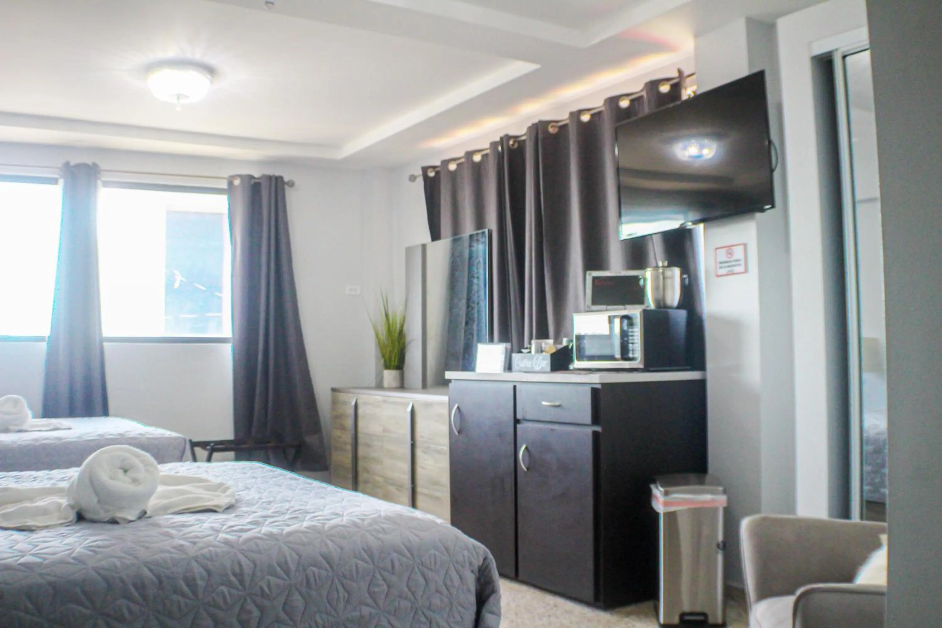 Bed in Itza-Bella Suites