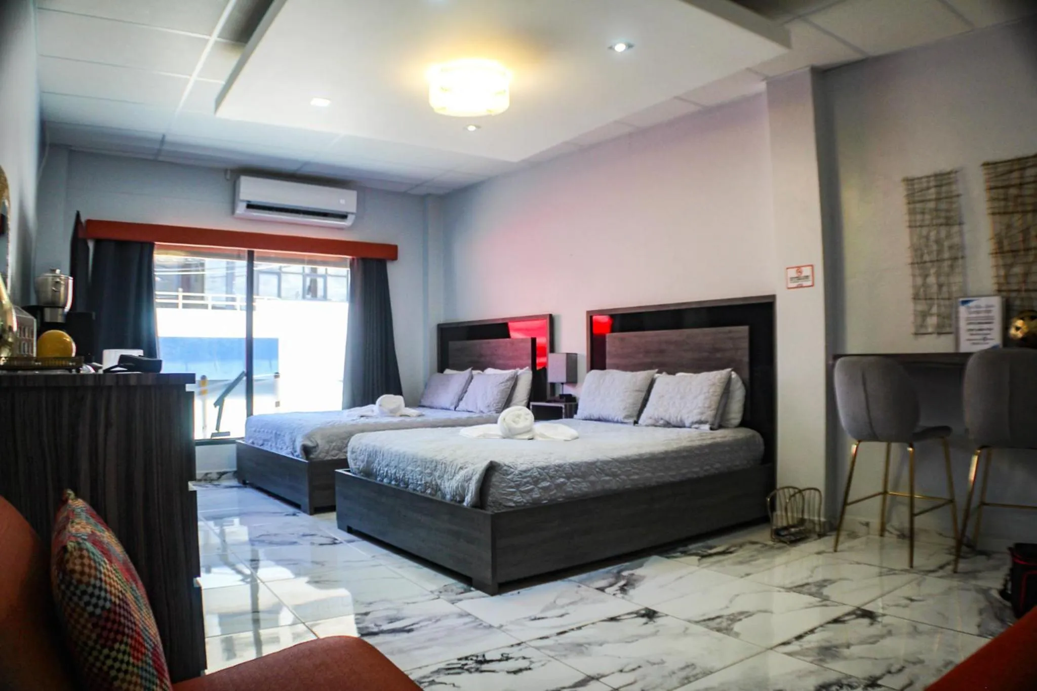 Bed in Itza-Bella Suites