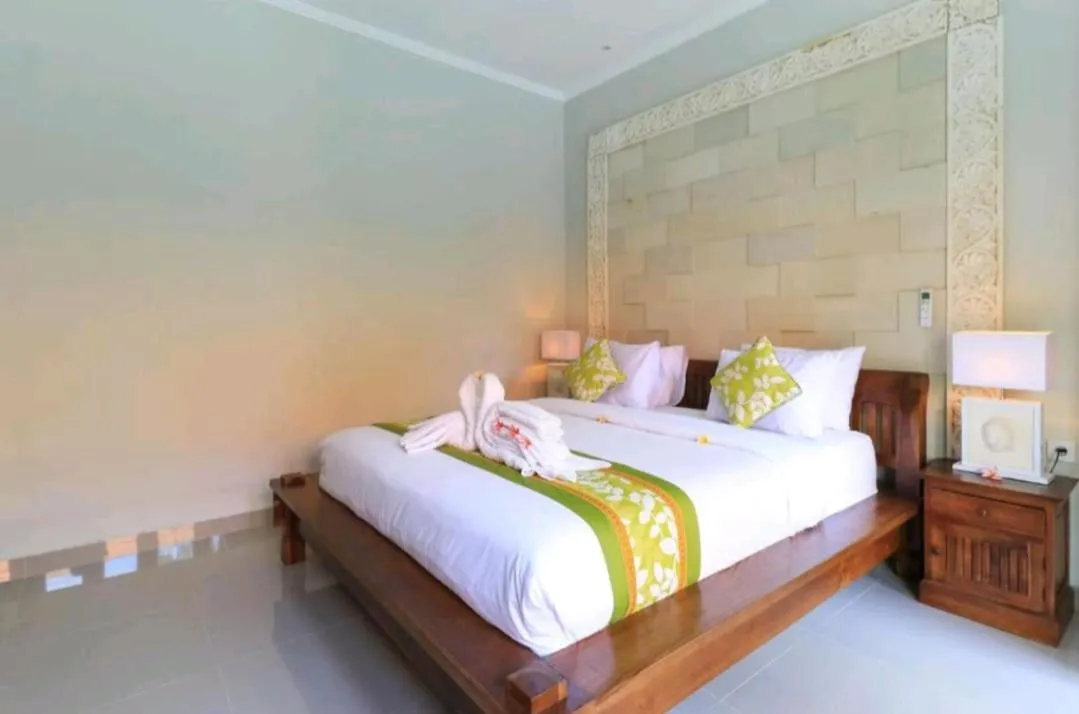 Bed in Three Brothers Bali Legian Bungalows & Villas