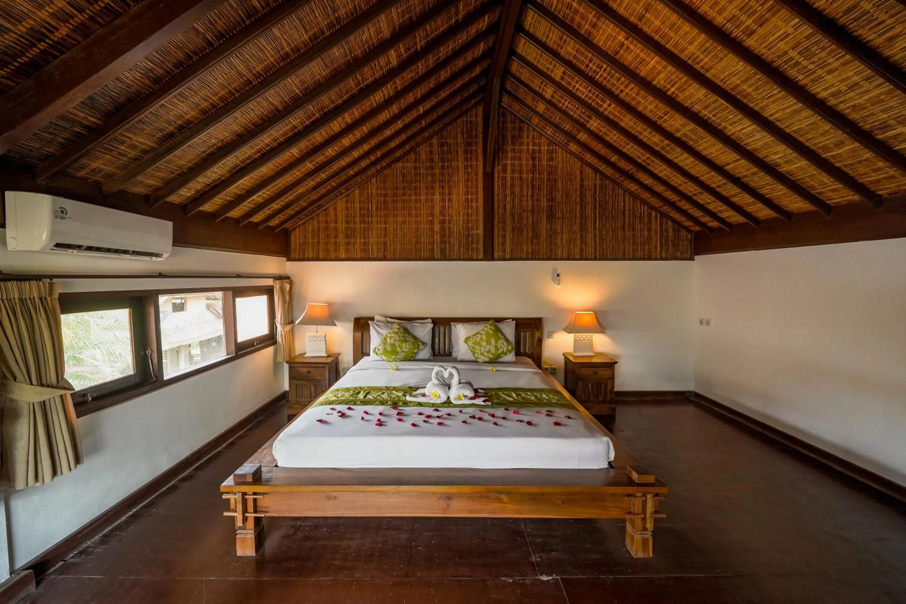Bed in Three Brothers Bali Legian Bungalows & Villas