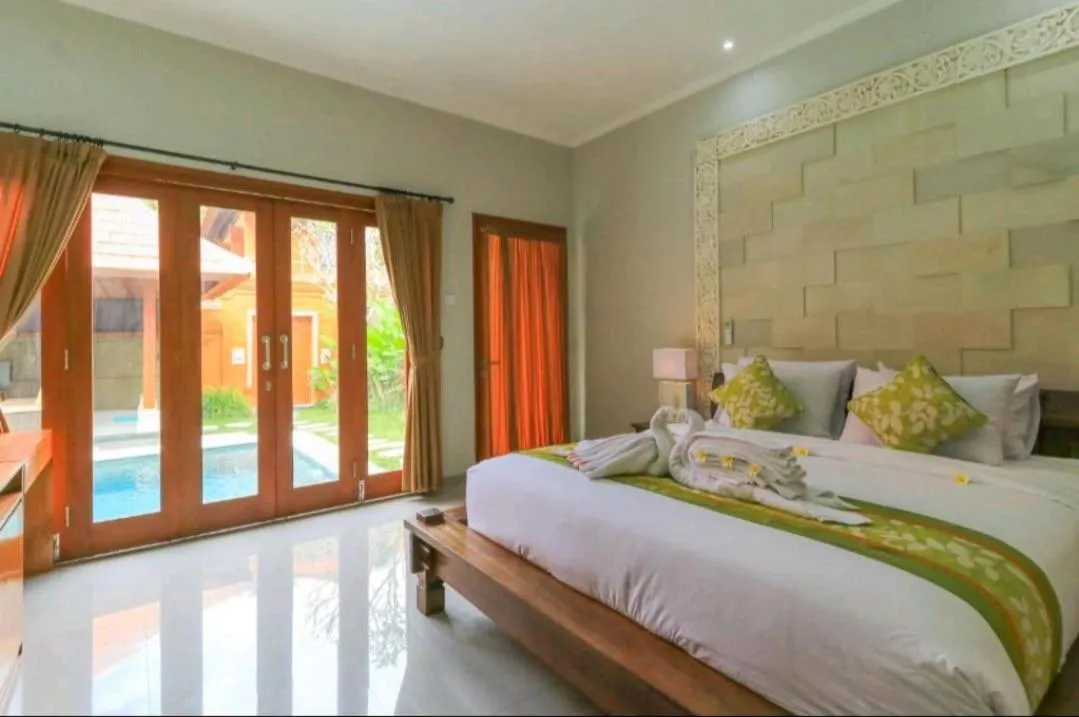 Bed in Three Brothers Bali Legian Bungalows & Villas