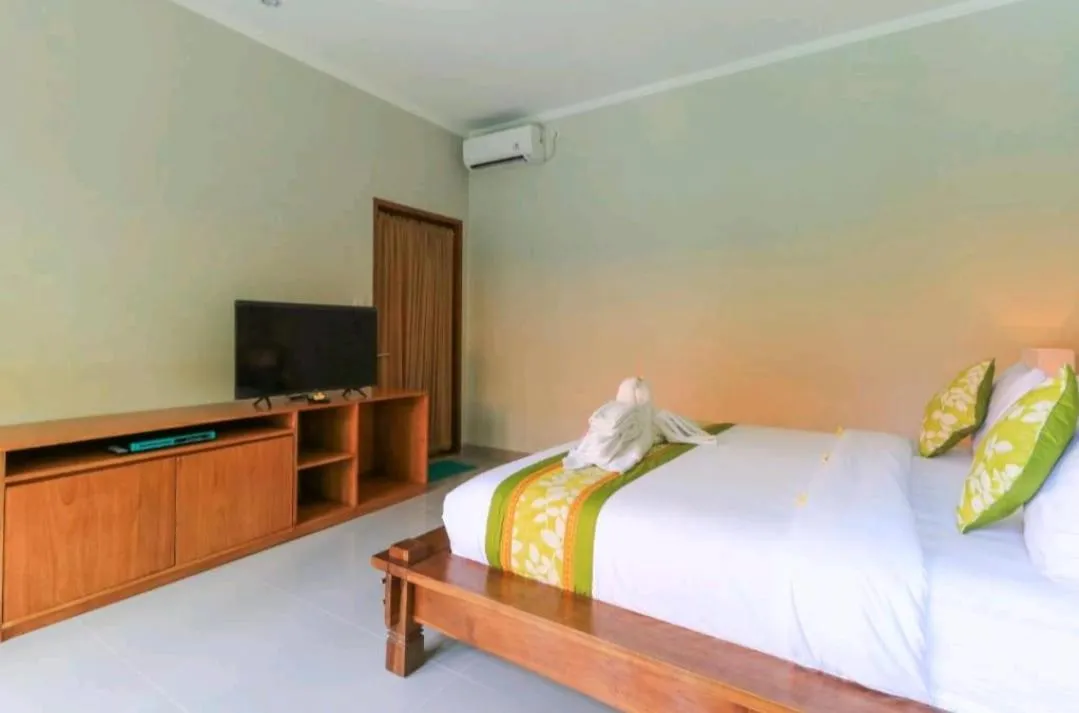 Bed in Three Brothers Bali Legian Bungalows & Villas