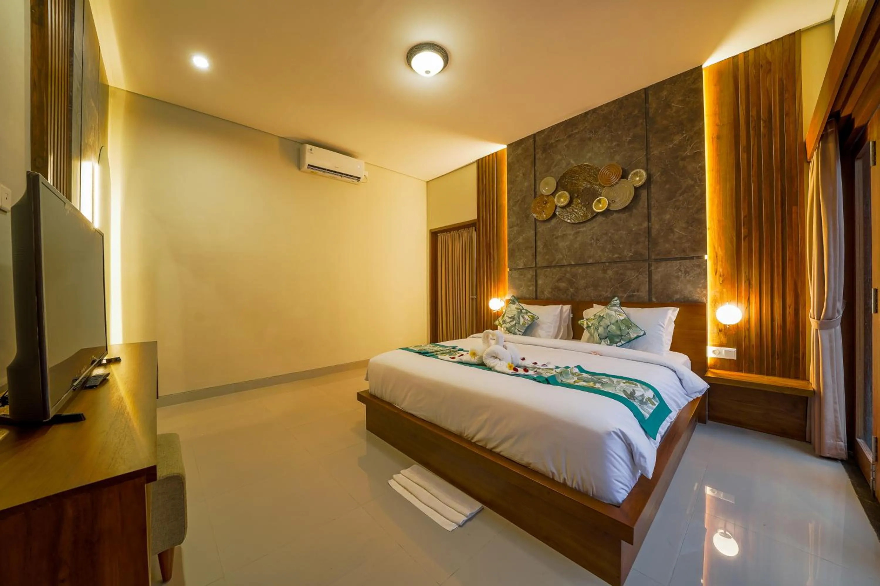 Bed in Three Brothers Bali Legian Bungalows & Villas