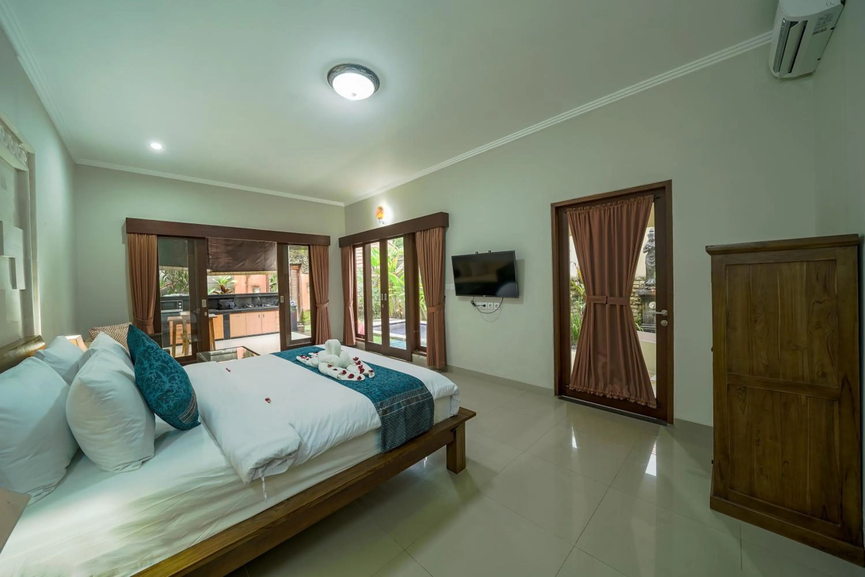Bed in Three Brothers Bali Legian Bungalows & Villas