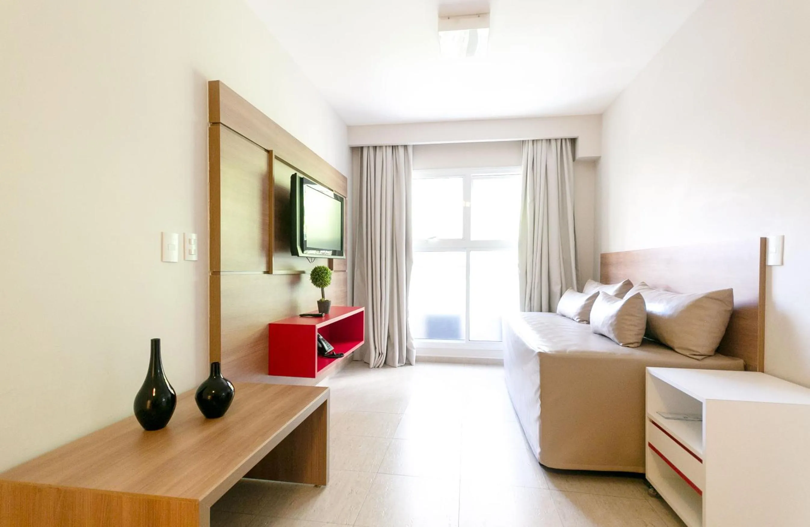 Living room, Bed in Ez Aclimação Hotel