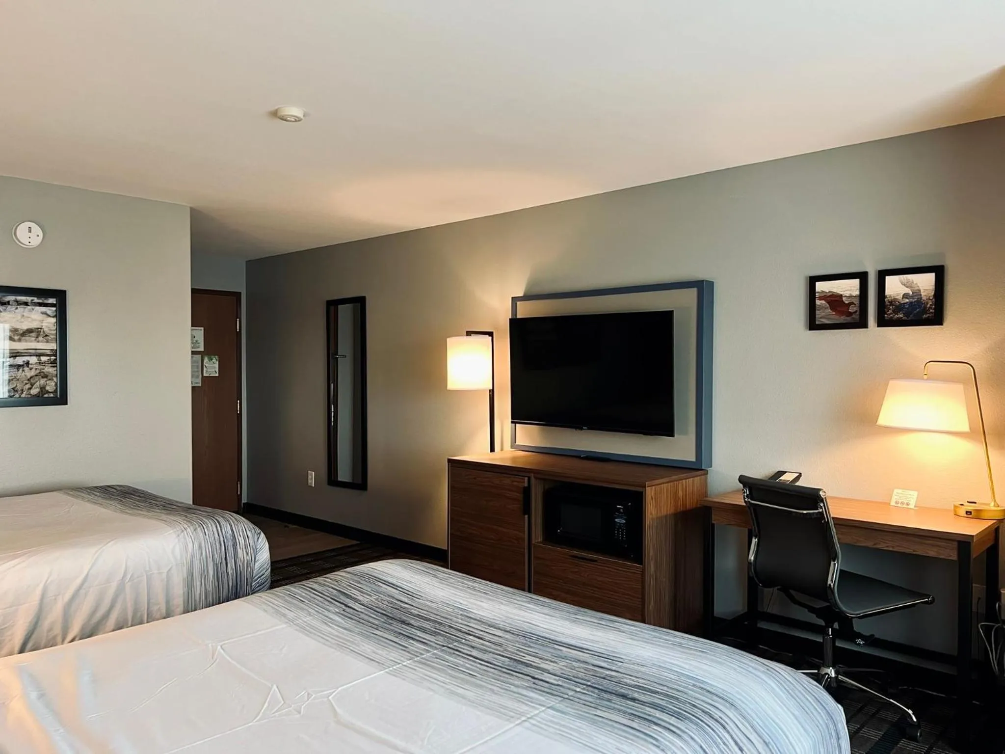 Bed in AmericInn by Wyndham Beaver Dam